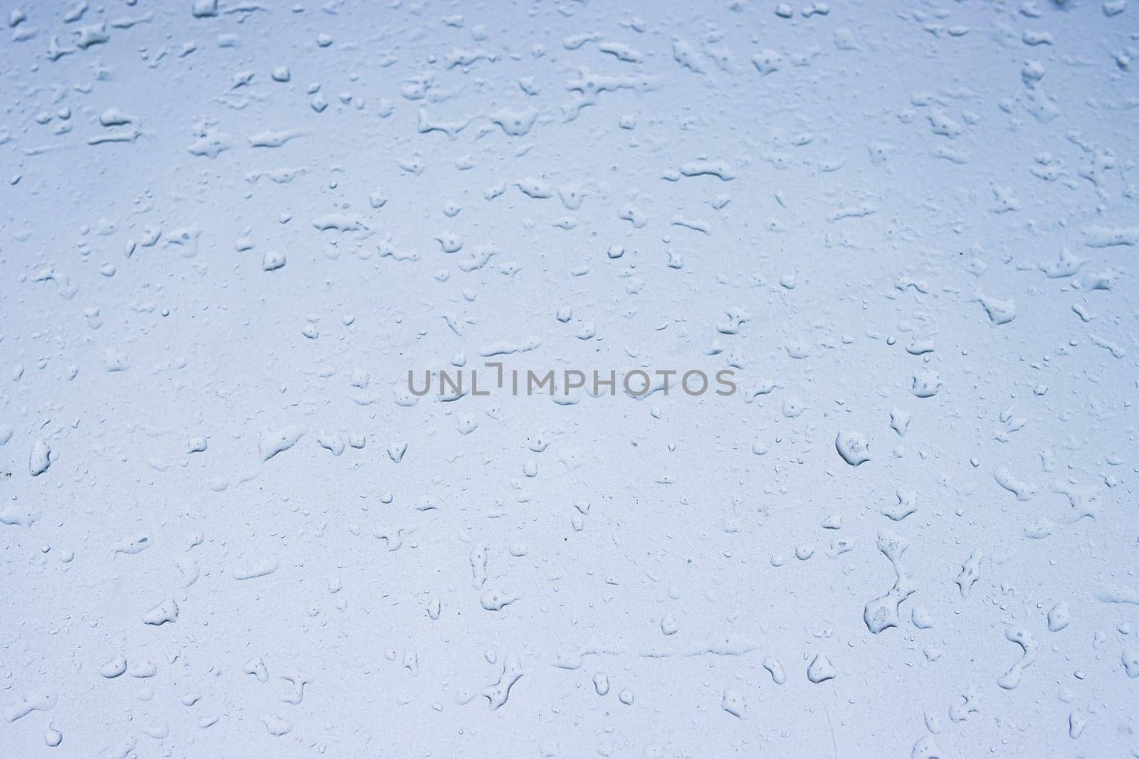 Drops of water on a light texture background. the background glass is covered with water drops. bubbles. High quality photo