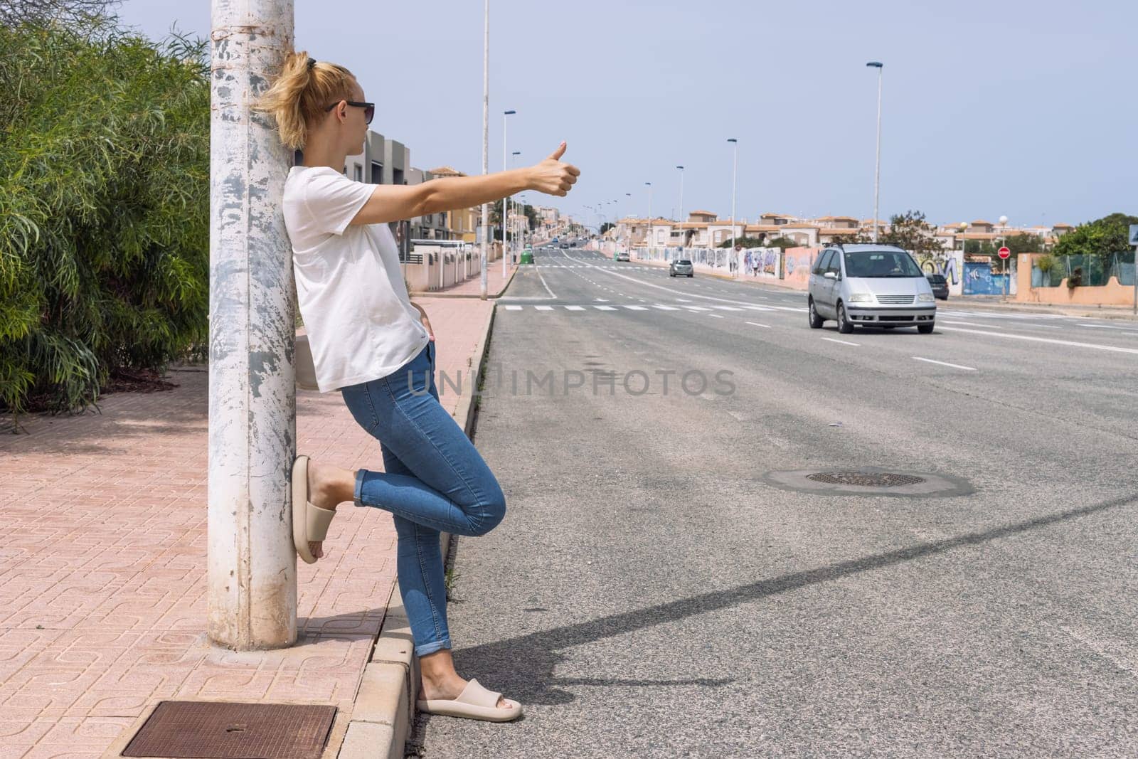 Young woman catches a car on the road, automatic stop, automatic braking, travel, travel. High quality photo