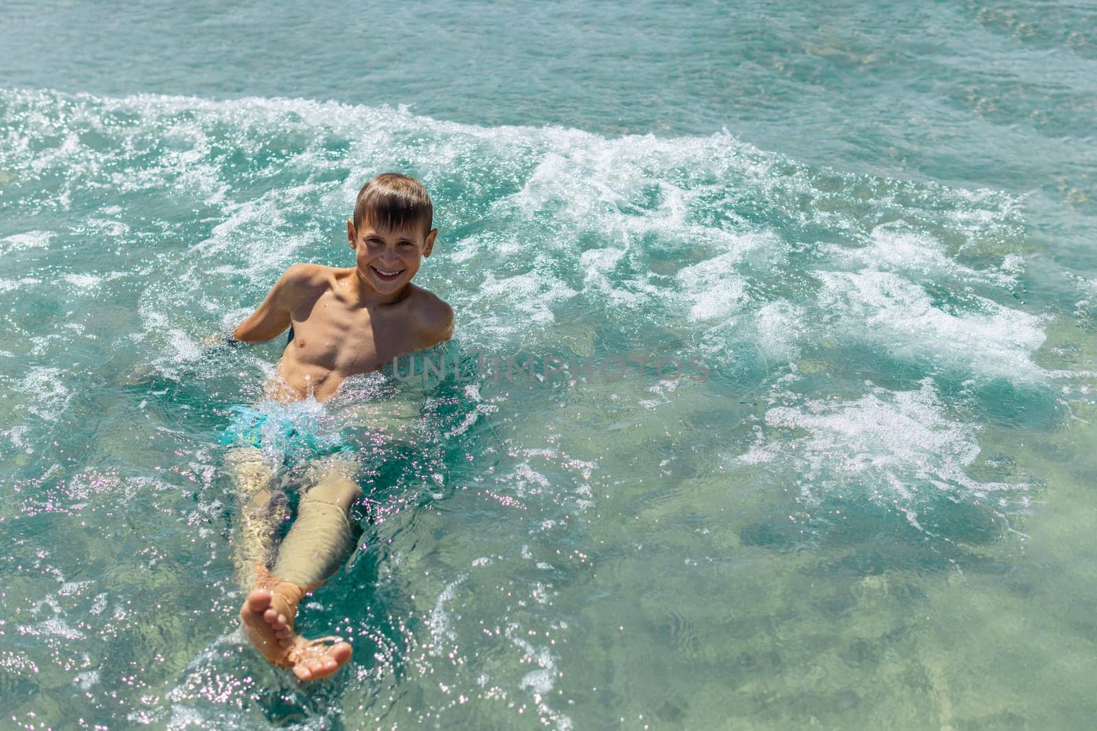 Happy boy swims and dives under water Active healthy lifestyle, water sports, seascape with a child there is a place for an inscription. High quality photo