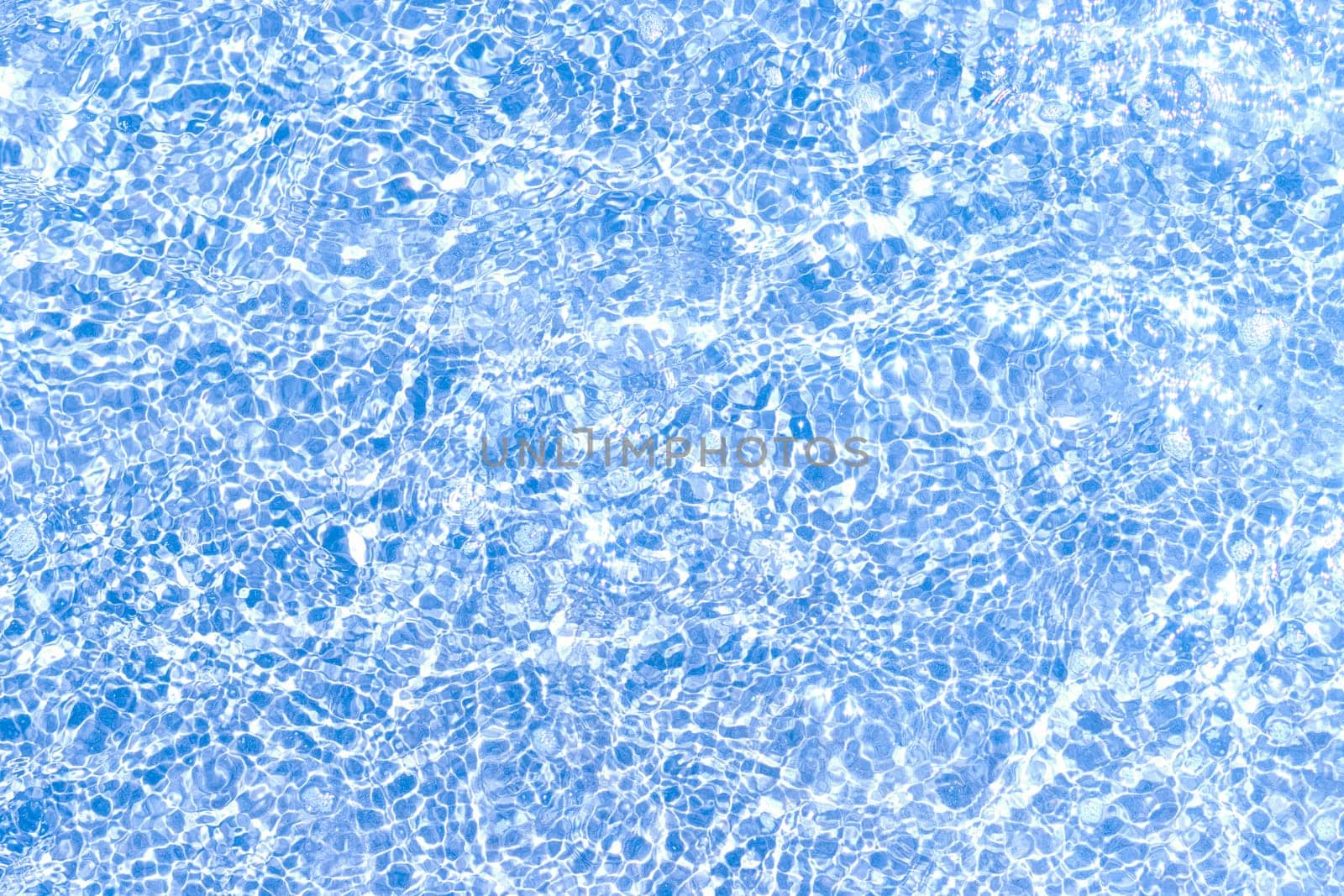 texture of blue tiles and water in the pool close-up, there is a place for an inscription. High quality photo