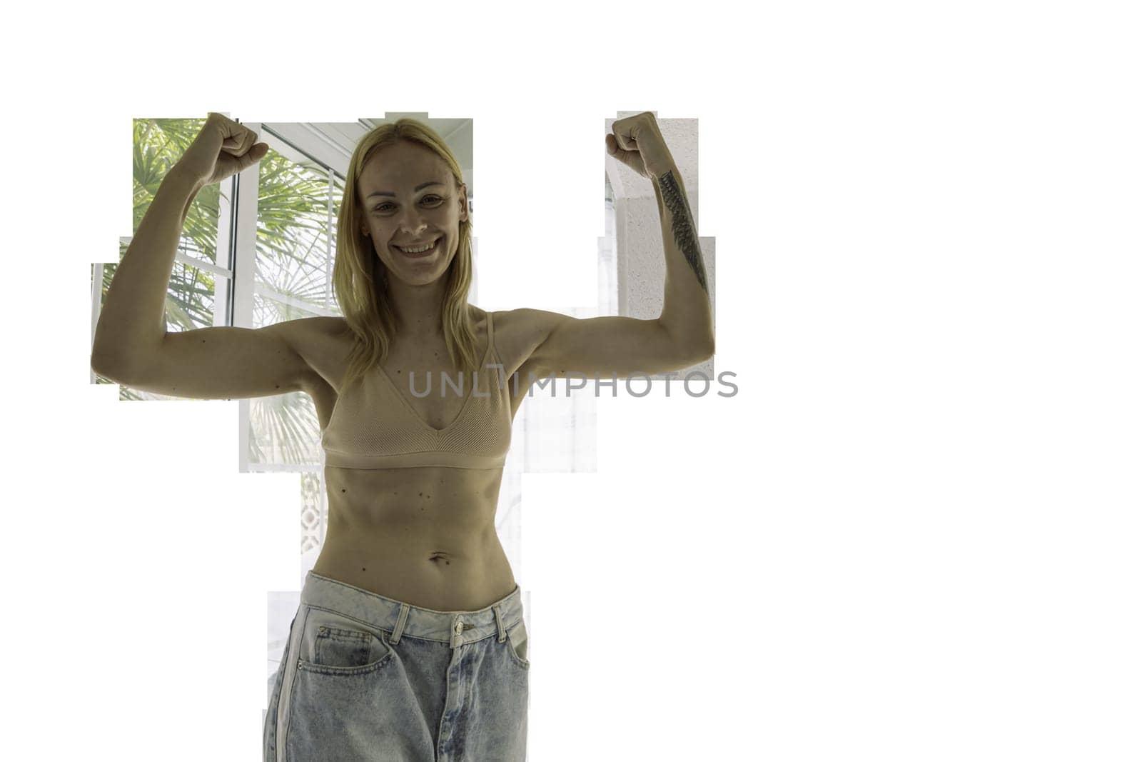 a happy girl of European appearance stands in a house in big jeans and shows the result of losing weight and proper nutrition.healthy lifestyle concept,PNG by PopOff