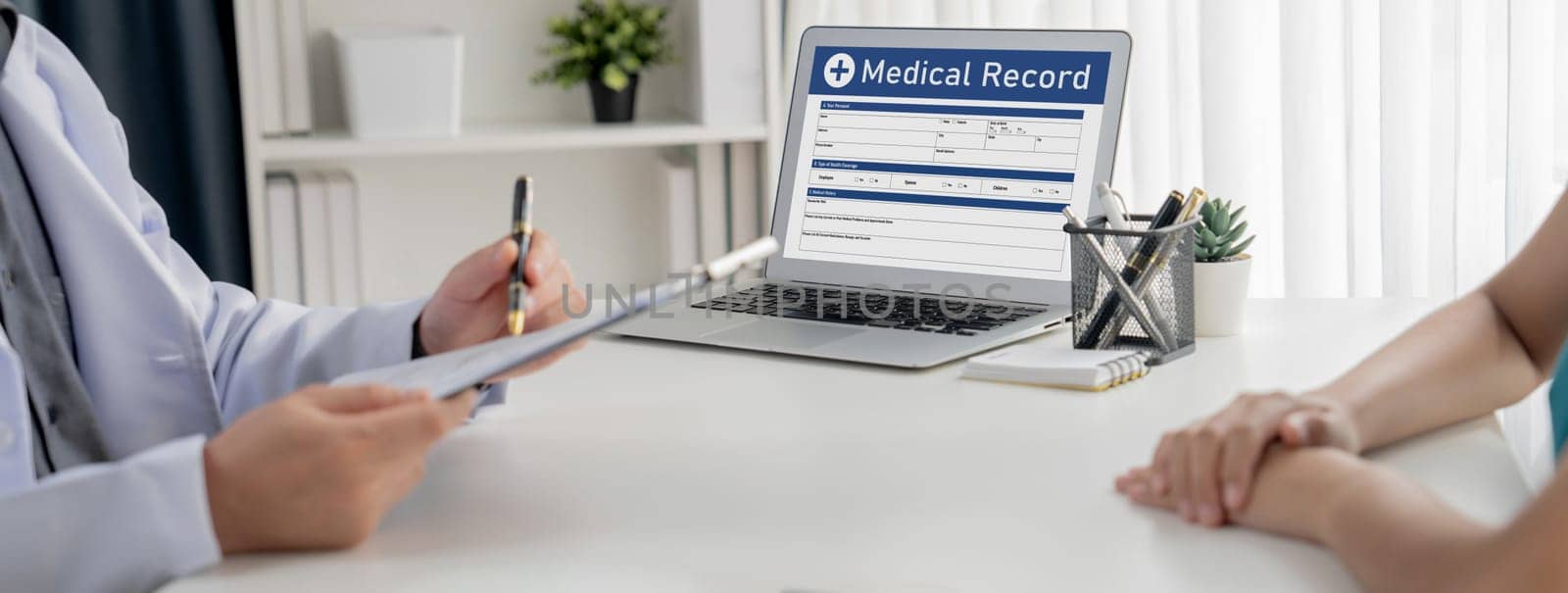 Focused laptop display medical report or diagnostic result of patient health on blurred background of doctor's appointment in hospital. Medical consultation and healthcare treatment. Panorama Rigid