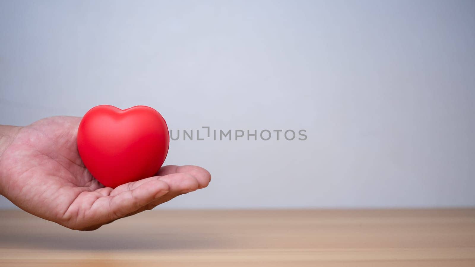 Good health and insurance concept, health insurance concept. Human hand holding red heart.