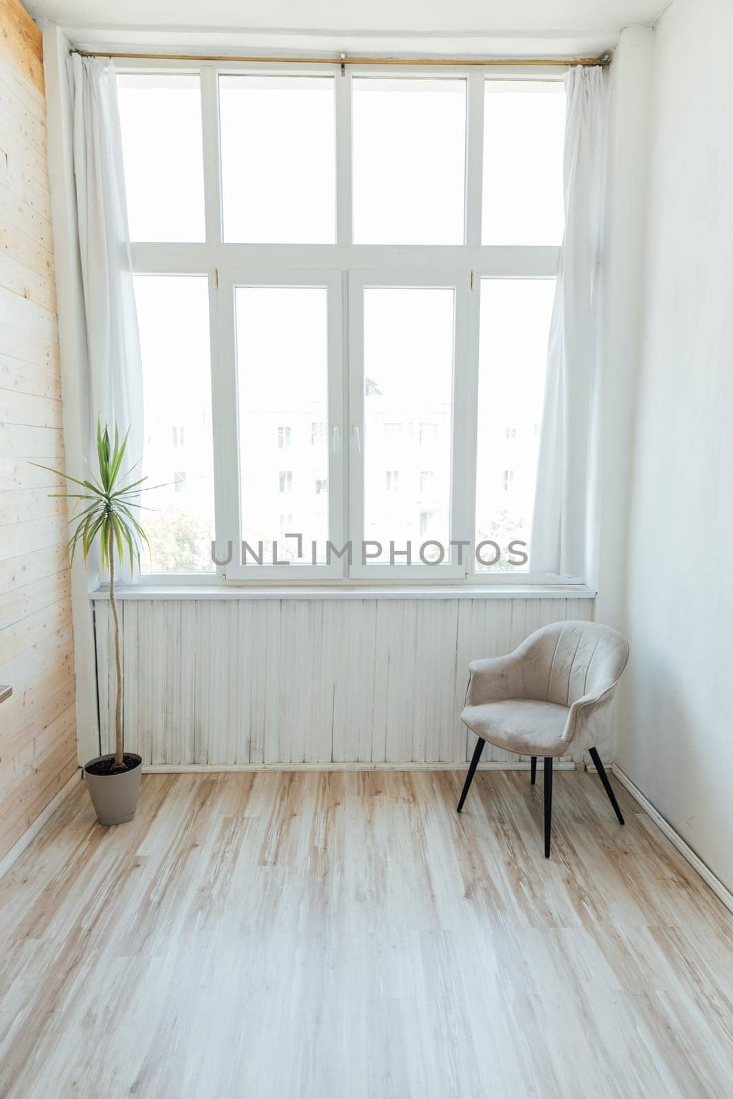 large spacious bright room with chair and large window by Simakov