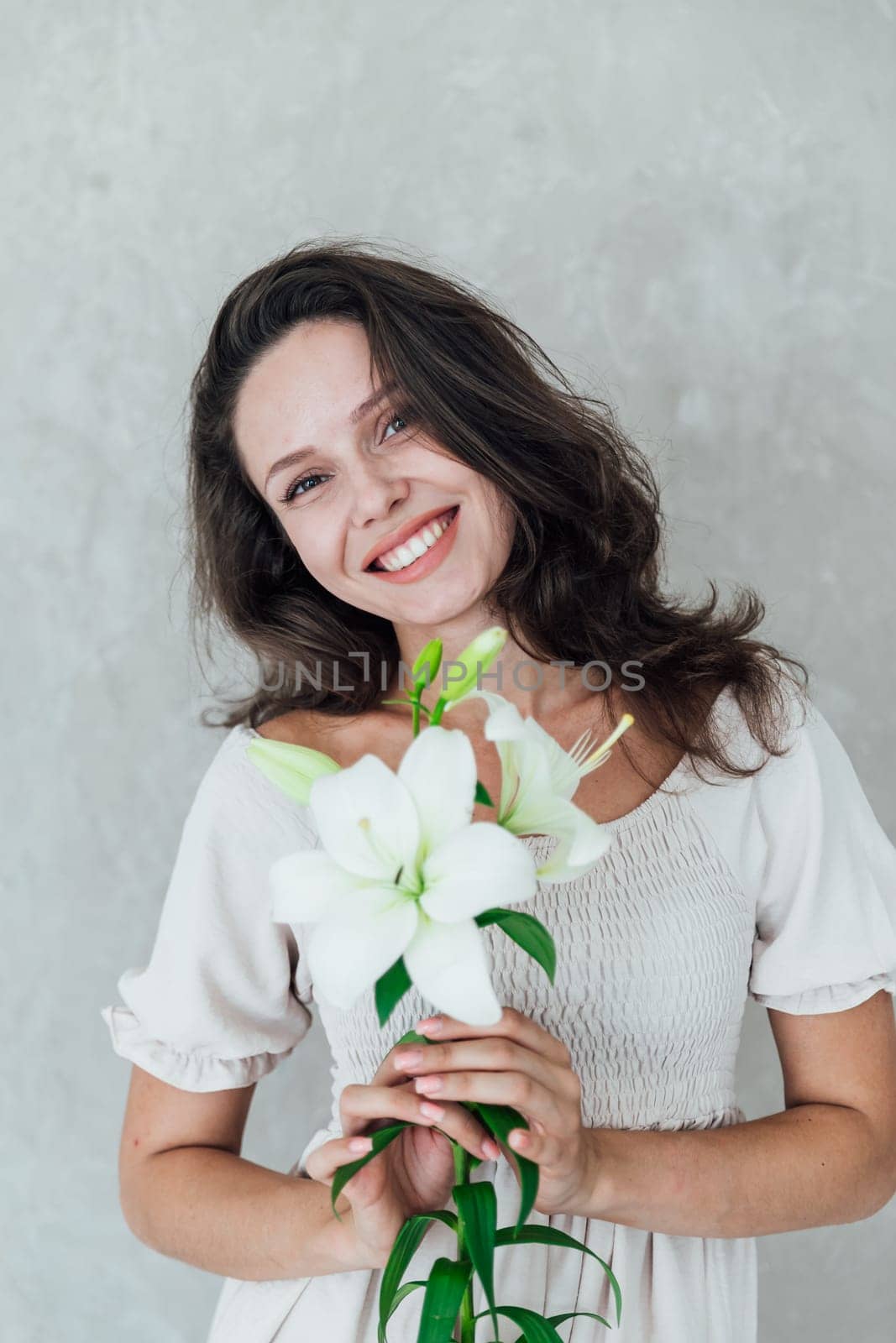 brunette woman in white dress with a white flowers