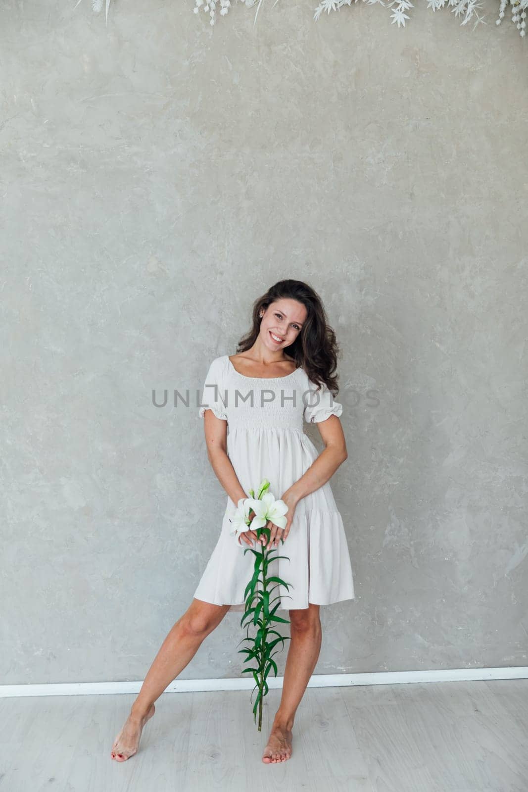 brunette woman in white dress with white flowers by Simakov