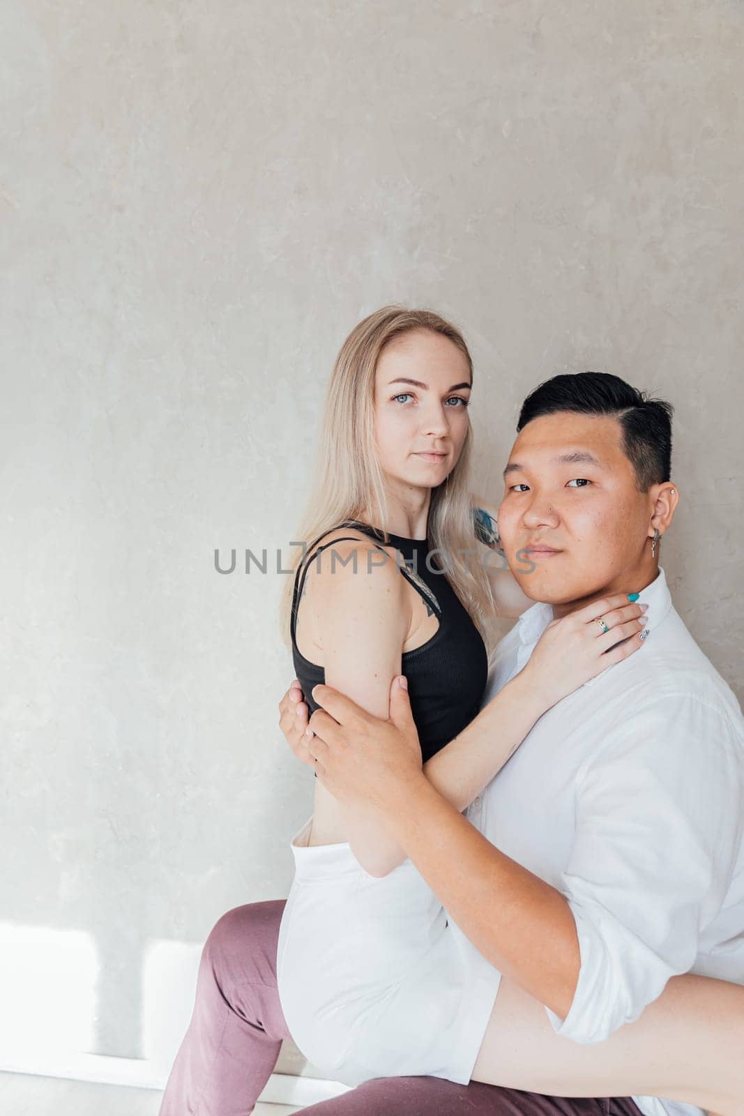 man and woman in love husband and wife couple woman sitting on a man by Simakov