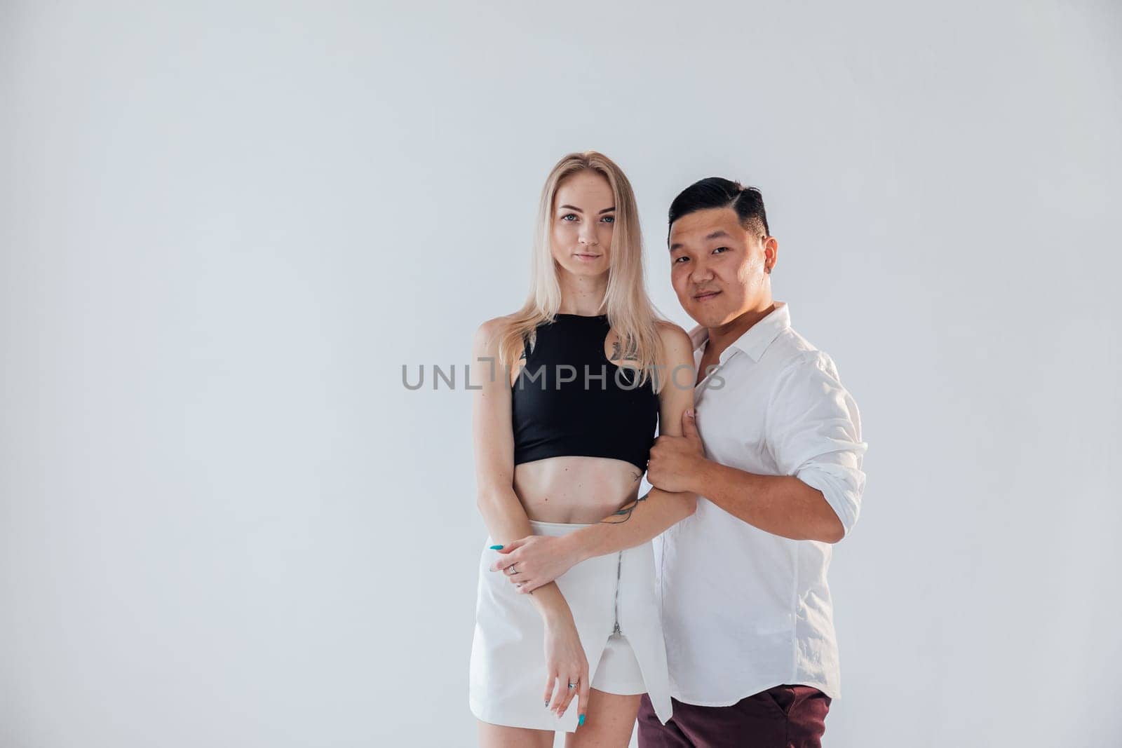 a man and a woman in love couple pose on a white background by Simakov