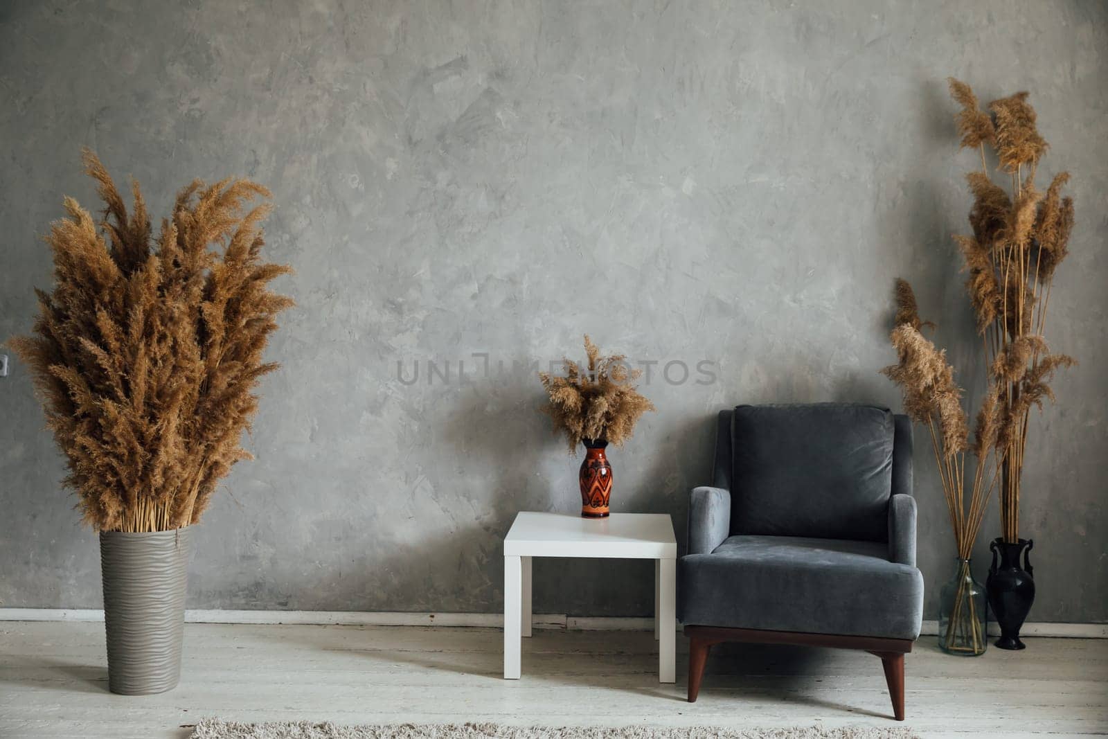 beautiful interior with white table and armchair on a gray background with fluffy colors by Simakov