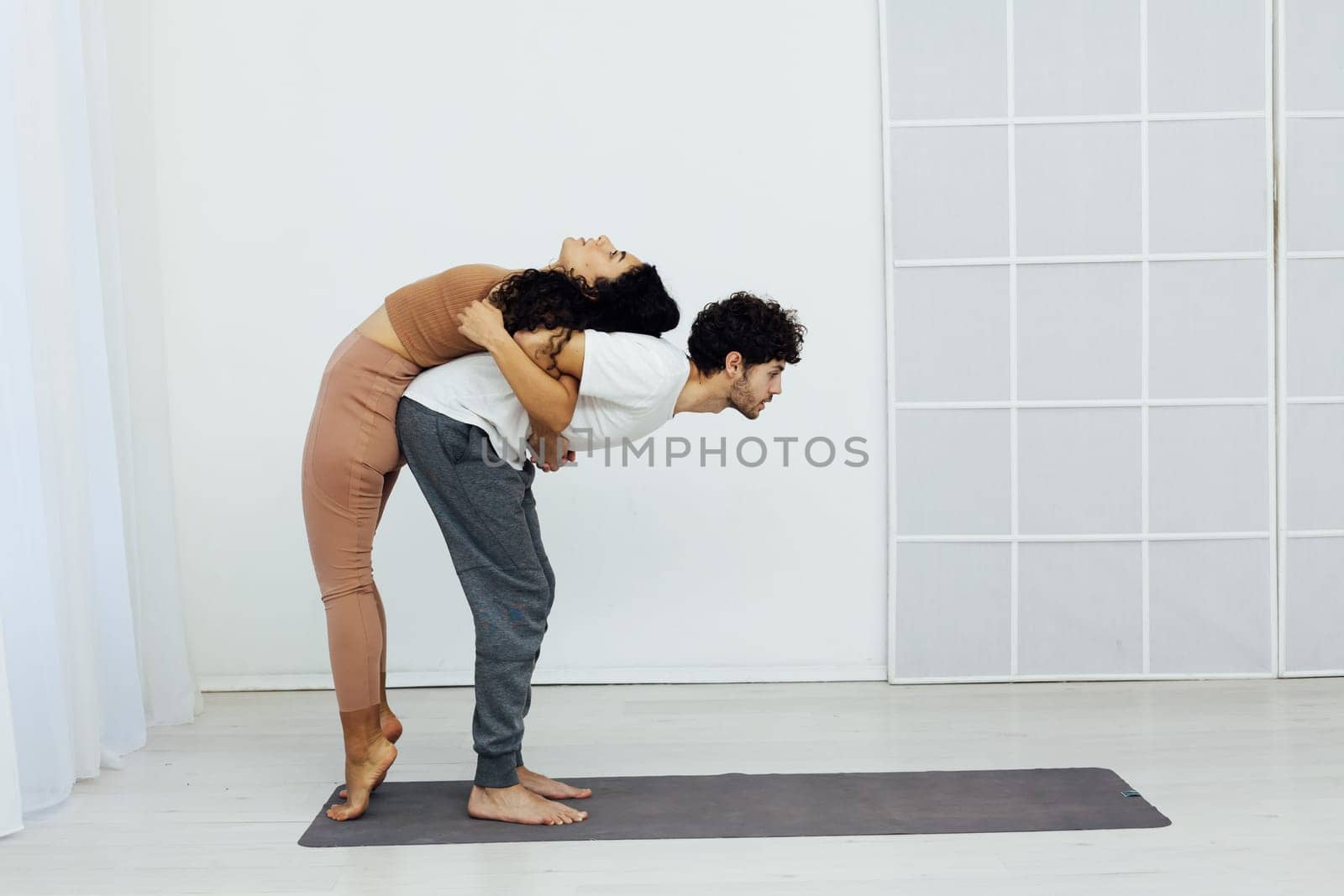 a man and woman do yoga exercises stretching acrobatics