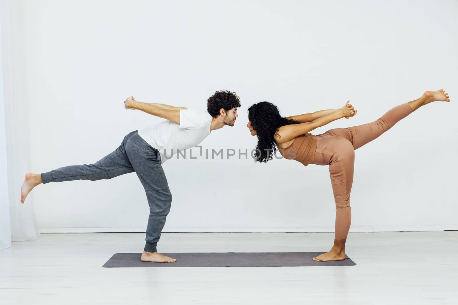 a man and woman engage in yoga training aerobics stretching