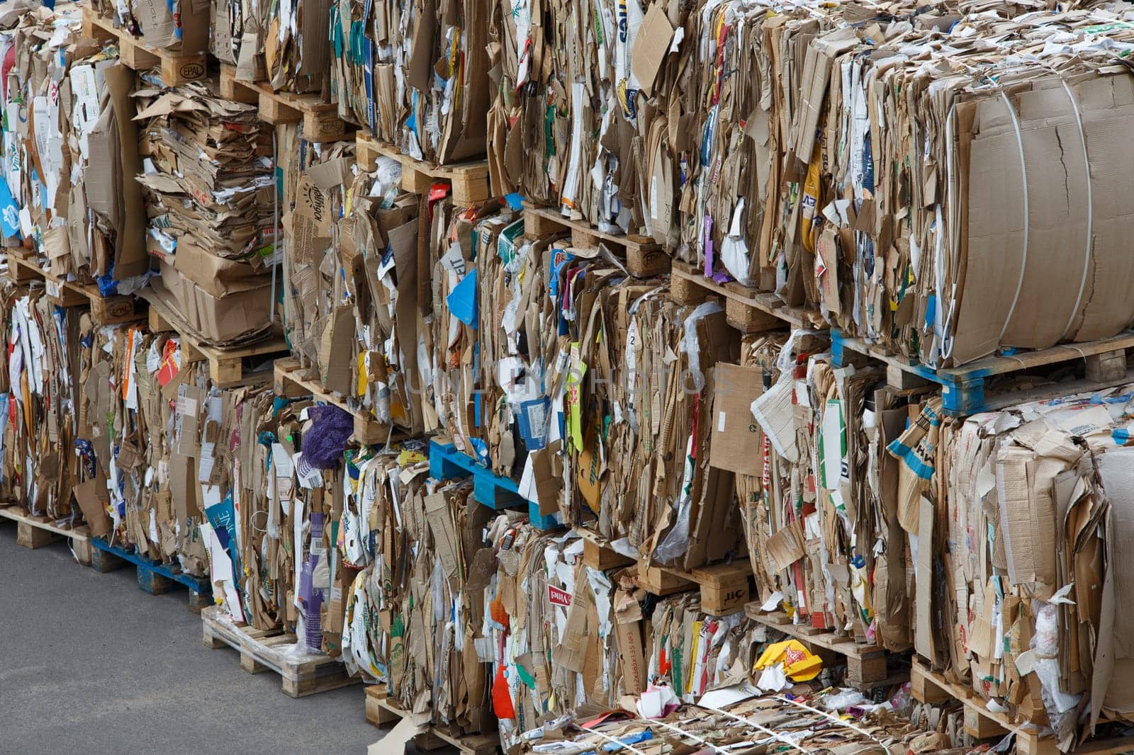 Crushed and compressed used cardboard packing poxes and paper stacked in Tula, Russia at August 3, 2021.