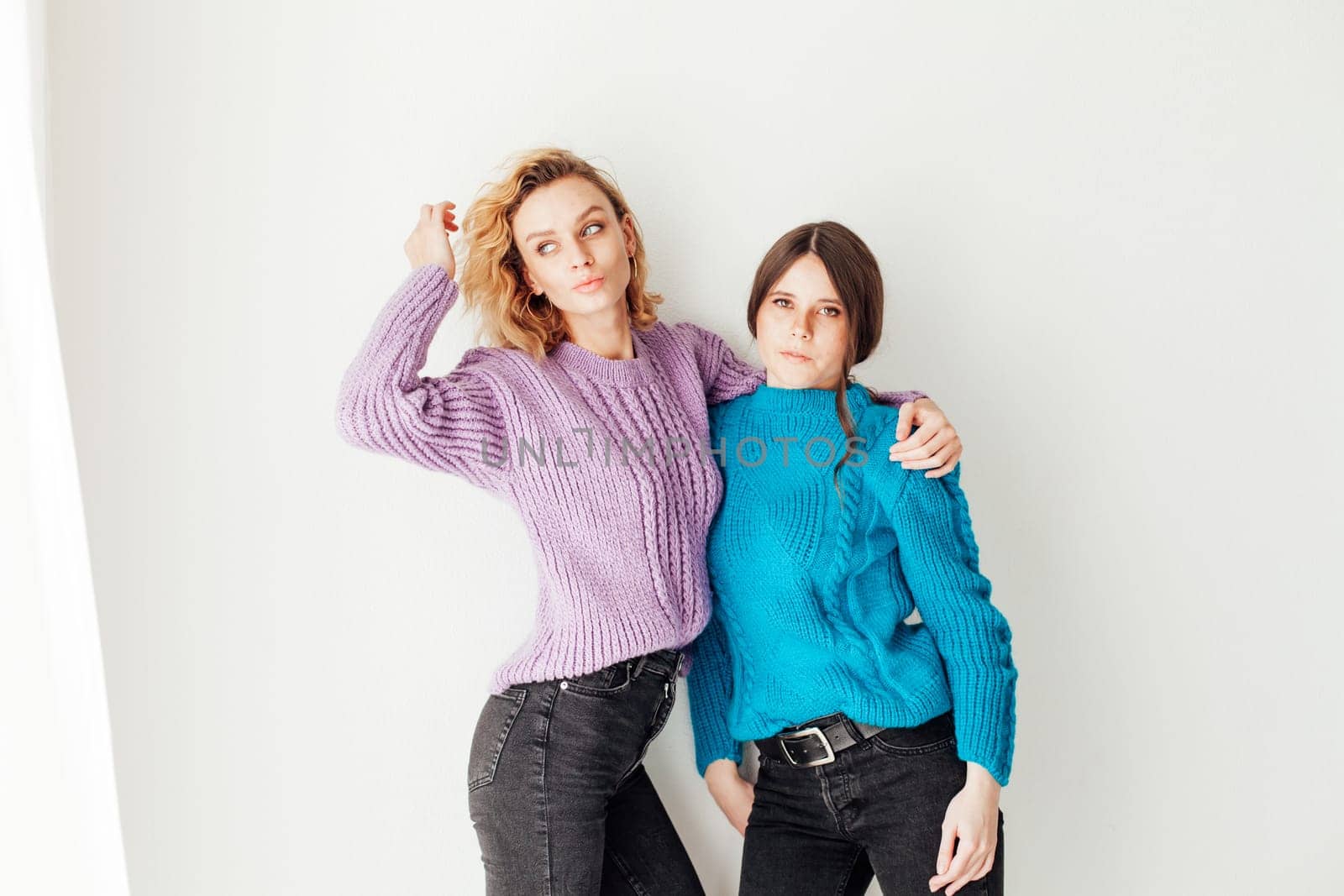 two friends in winter clothes women in sweaters by Simakov