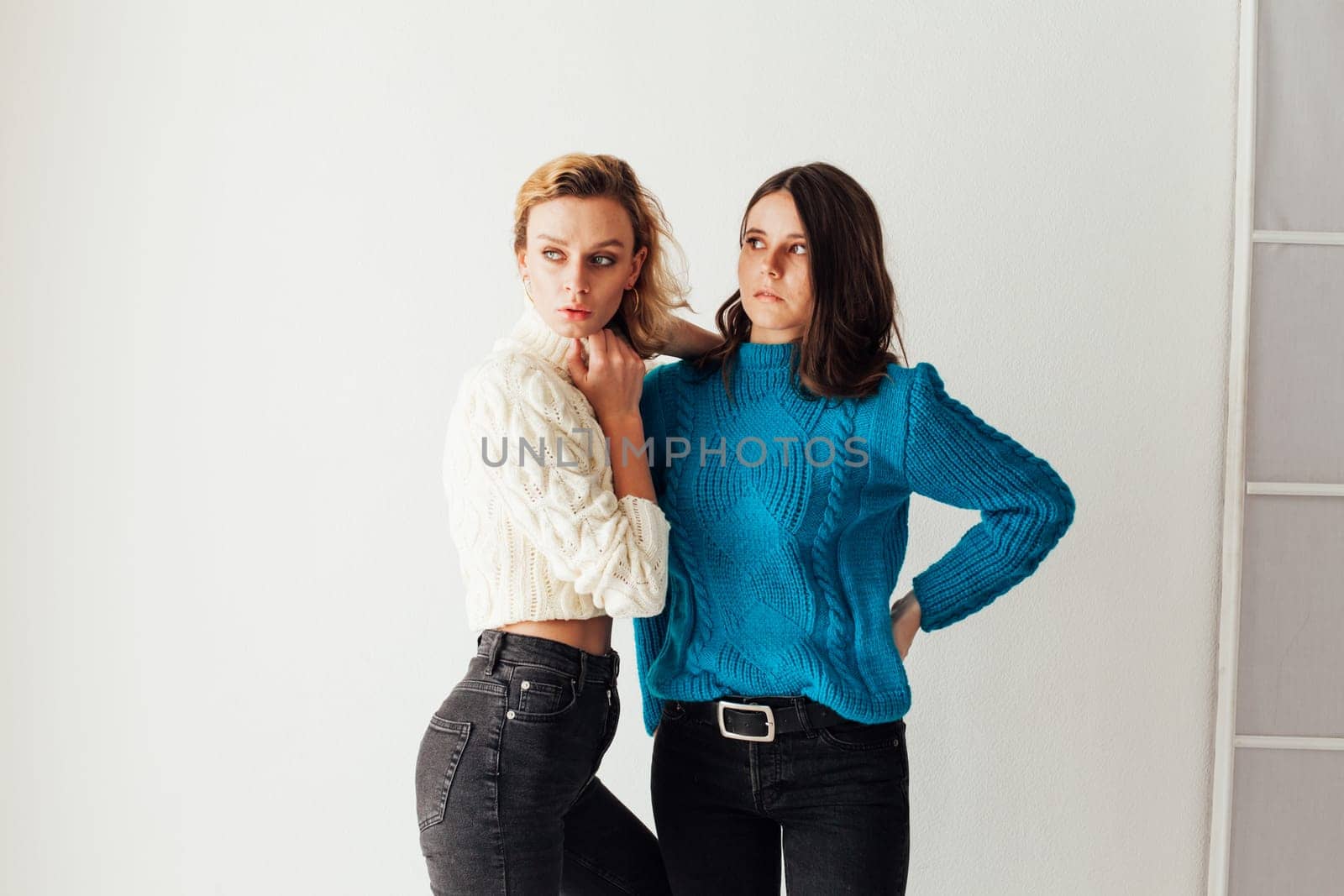 two friends in winter clothes women in sweaters by Simakov