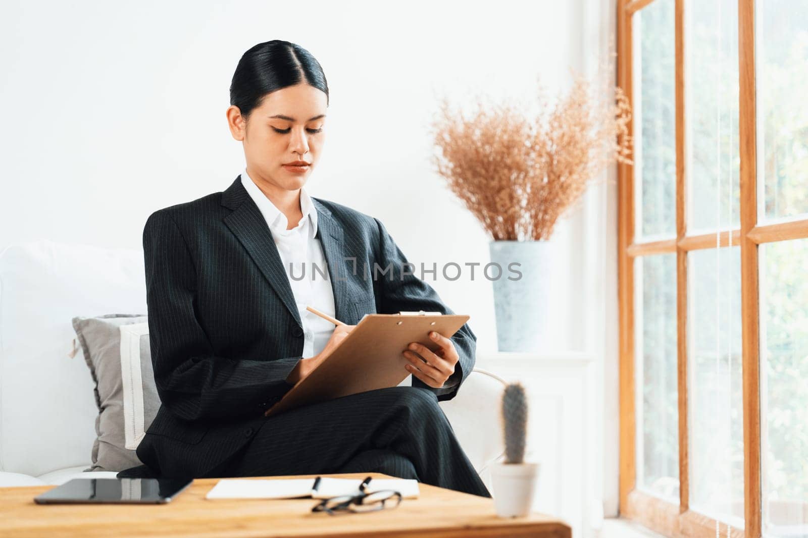 Psychologist woman in clinic office professional portrait with friendly smile feeling inviting for patient to visit the psychologist. The experienced and confident psychologist is uttermost specialist