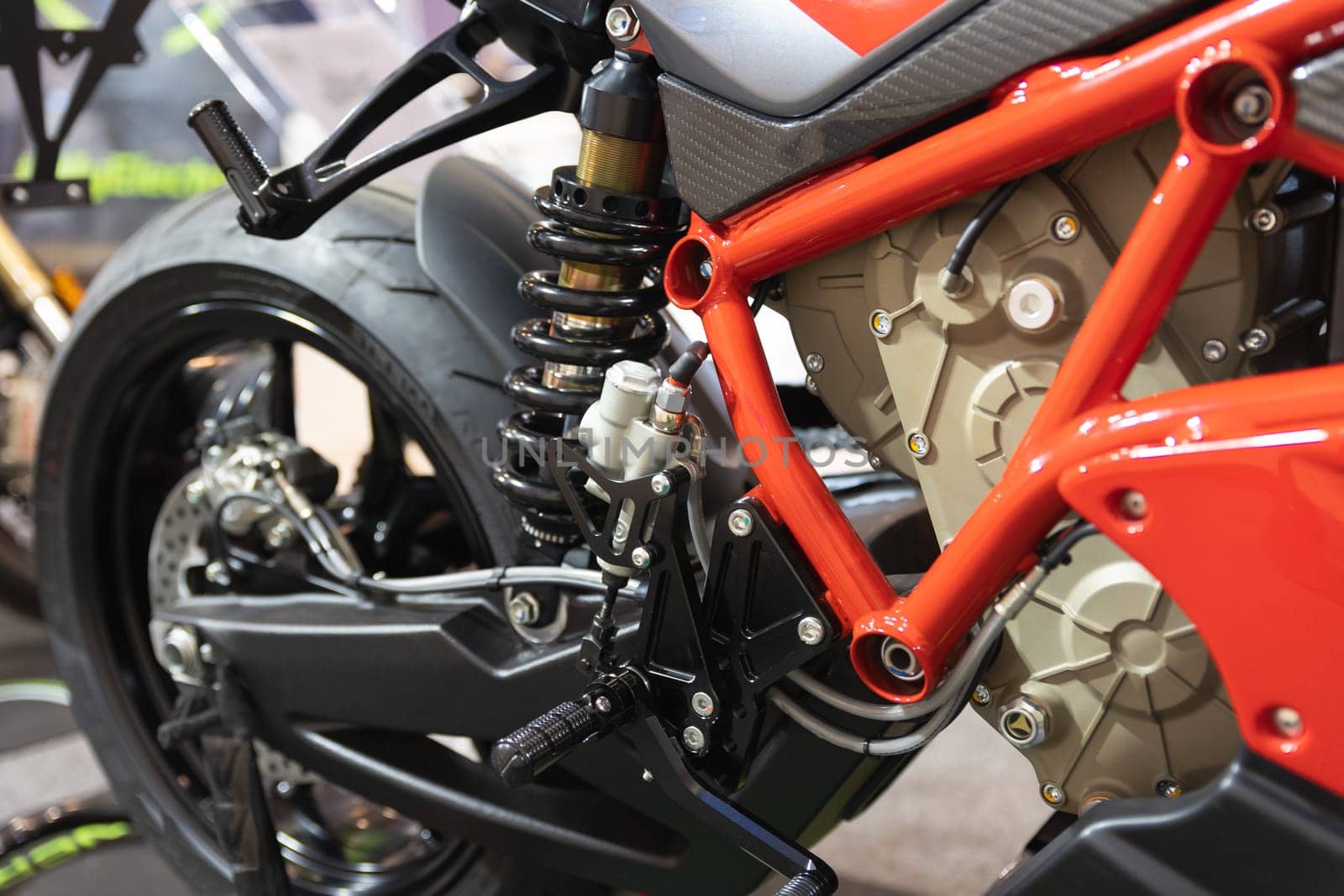 A Close Up of a Motorcycle Parked in a Garage with Electric Cars by Studia72