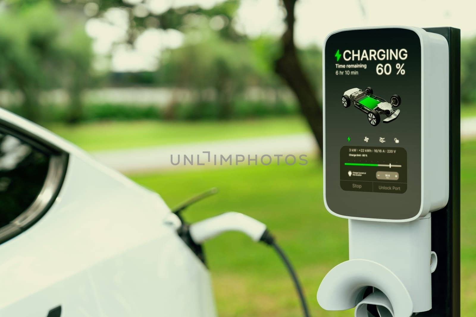 EV electric vehicle recharging battery from EV charging station in outdoor green city park scenic. Natural protection with eco friendly EV car travel. Exalt