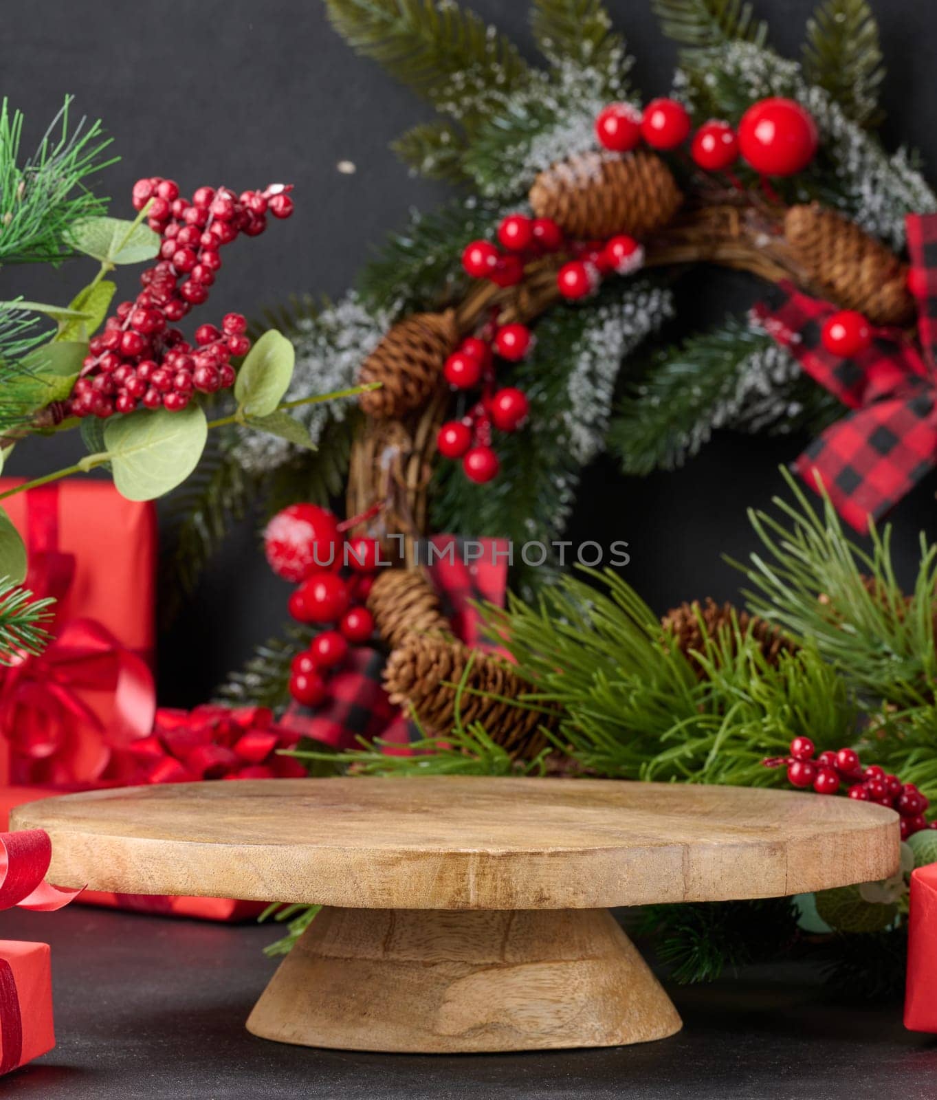Empty round wooden platform for displaying products in the middle of Christmas decor by ndanko