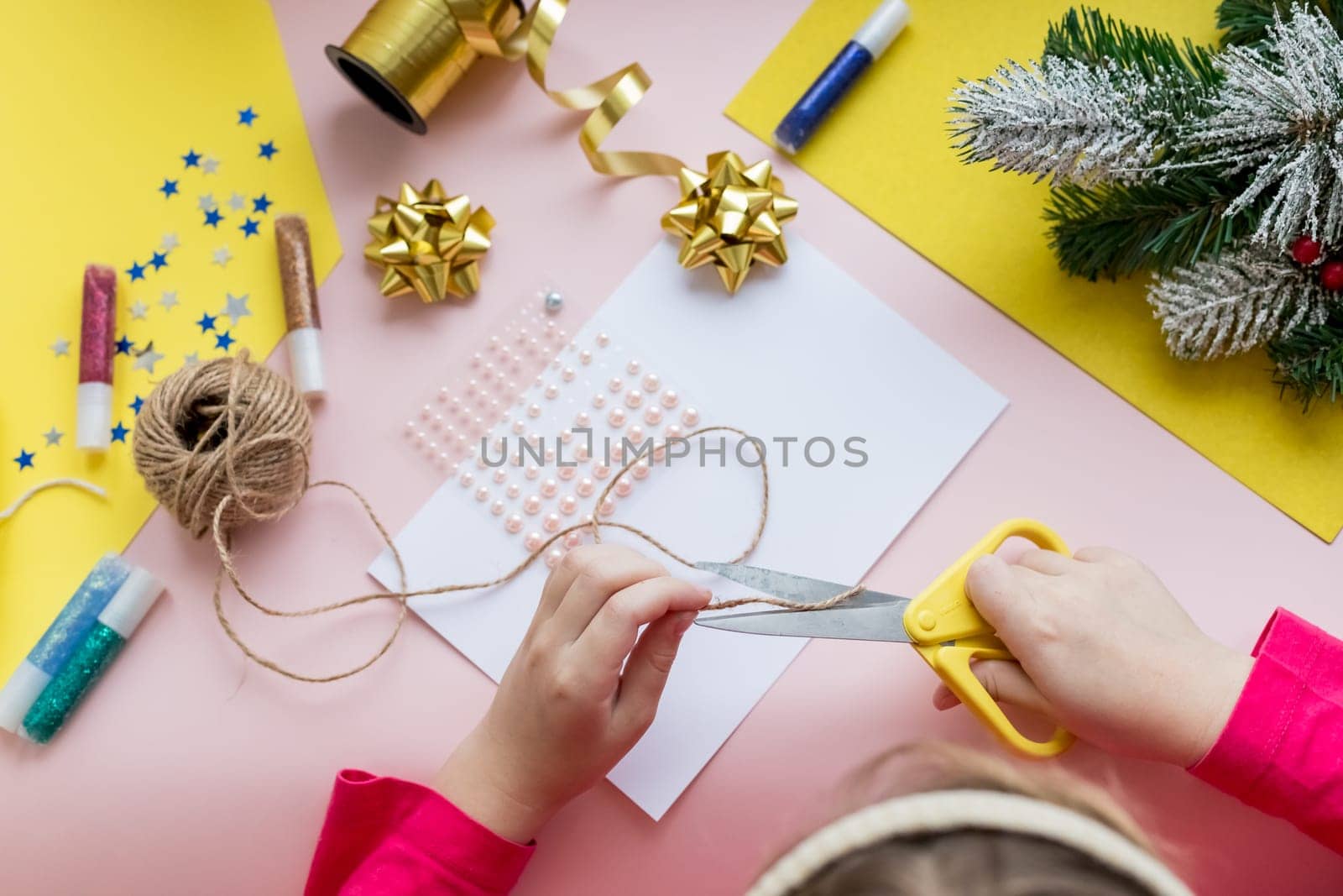 the child makes a New Year card for the winter holidays. DIY crafts and crafts for Christmas do-it-yourself concept