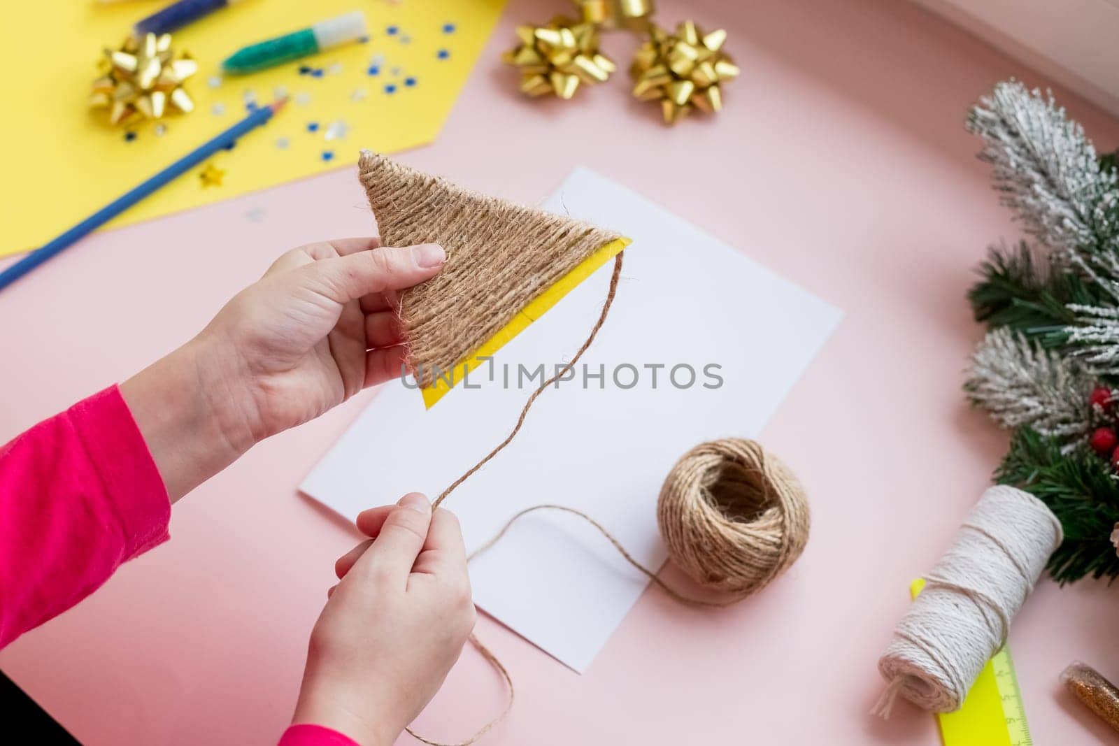 the child makes a New Year card for the winter holidays. DIY crafts and crafts for Christmas do-it-yourself concept