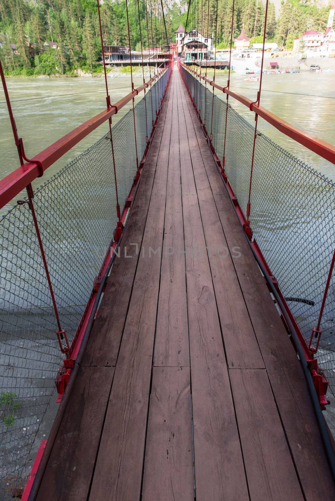 Famous bridge over Katun river in valley of Altai Mountains. Popular landmark in Altai, Siberia, Russia.