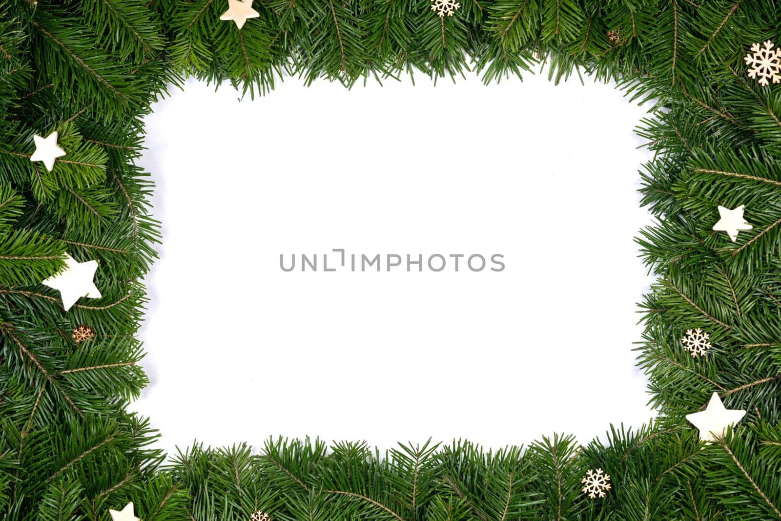 Christmas border arranged with fresh fir branches and wooden decor isolated on white background , copy space for text