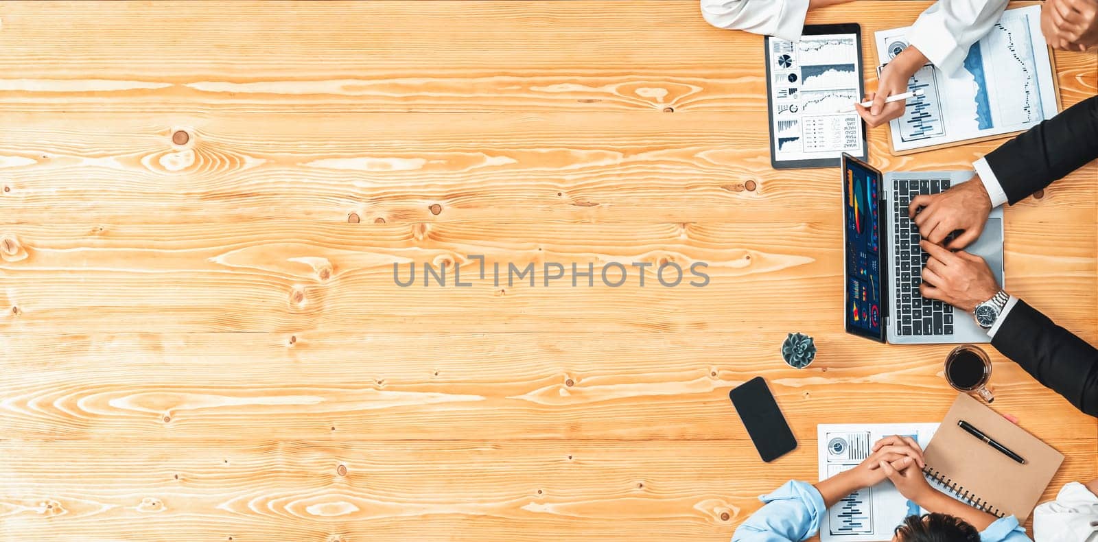 Panorama top view diverse group of business analyst team analyzing financial data report paper on meeting table. Chart and graph dashboard by business intelligence analysis. Meticulous