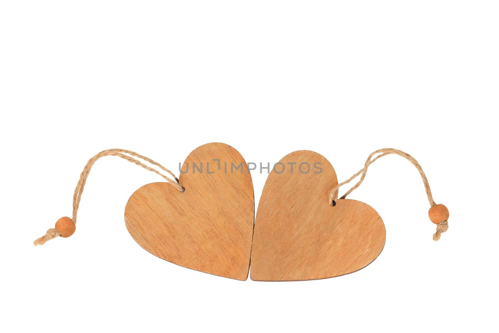Two wooden hearts lie side by side isolated on a white background. Valentine's day greeting Card.