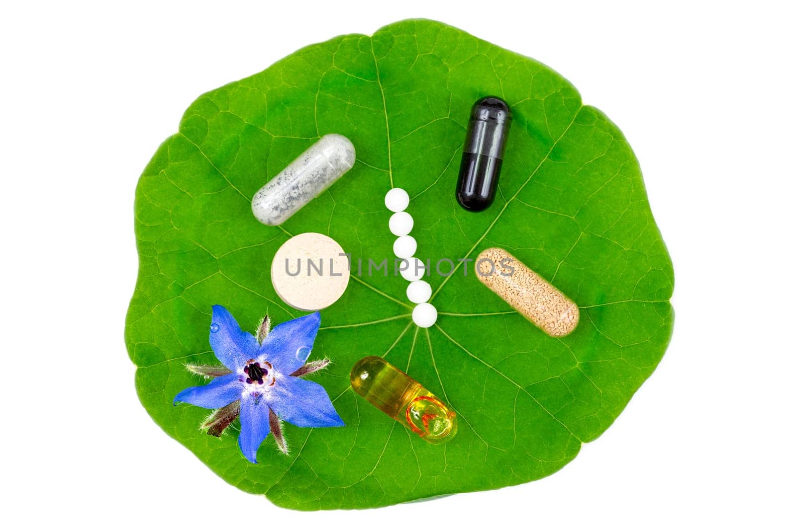 isolated Green herbal pills on a White background with space for text. Pharmaceutical industry. Vitamins and suplements.