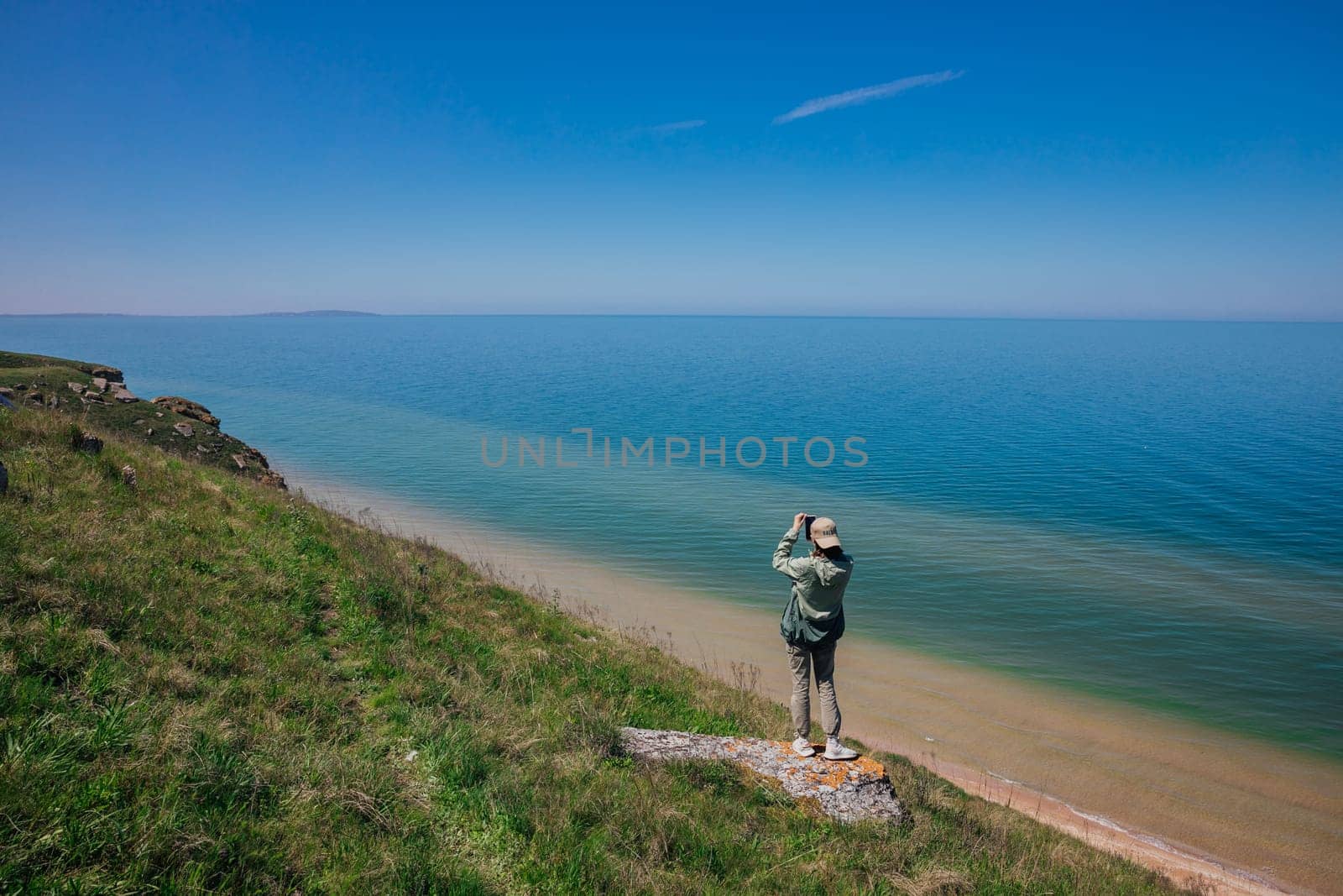 man photographing nature sea sky travel hiking by Simakov