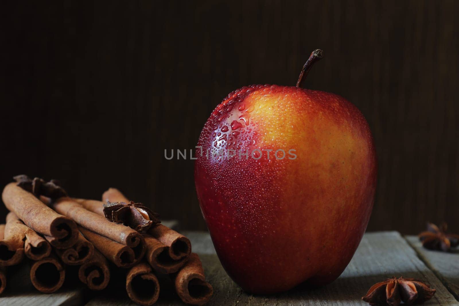 Red apple, anise and vanilla on the table