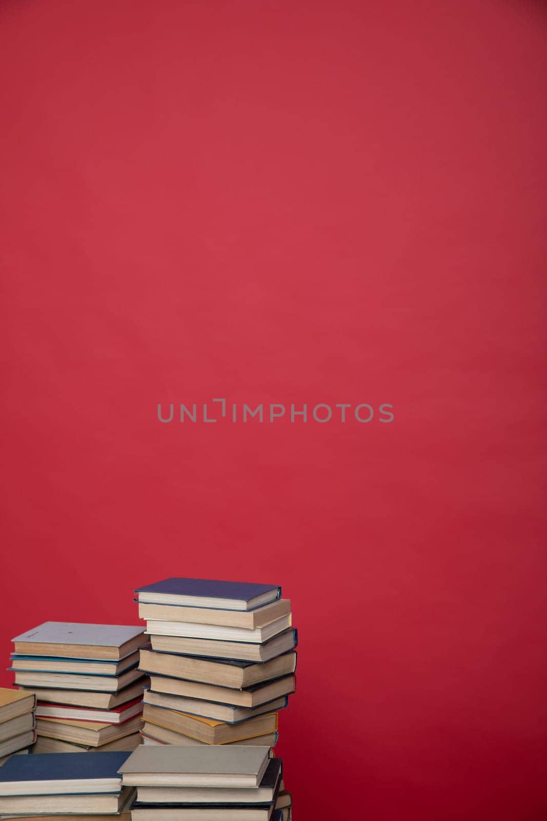 education science learning library stack of books on a red background by Simakov