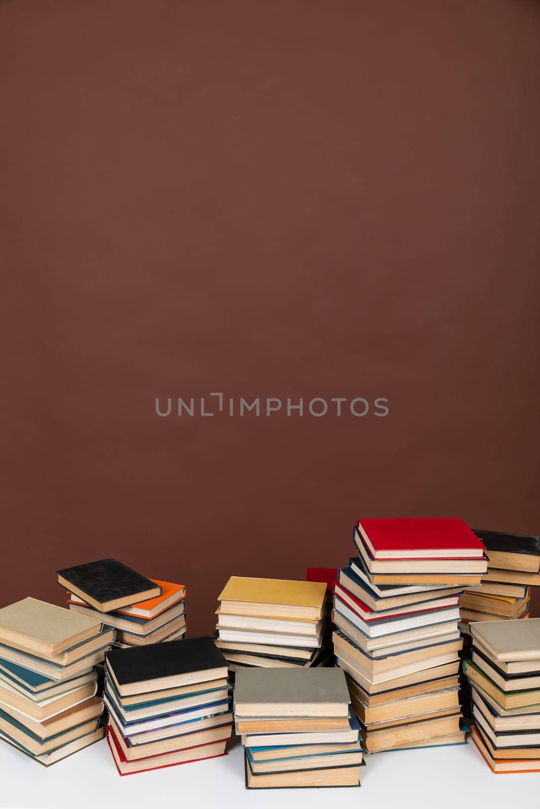 an education science learning library stack of books on brown background