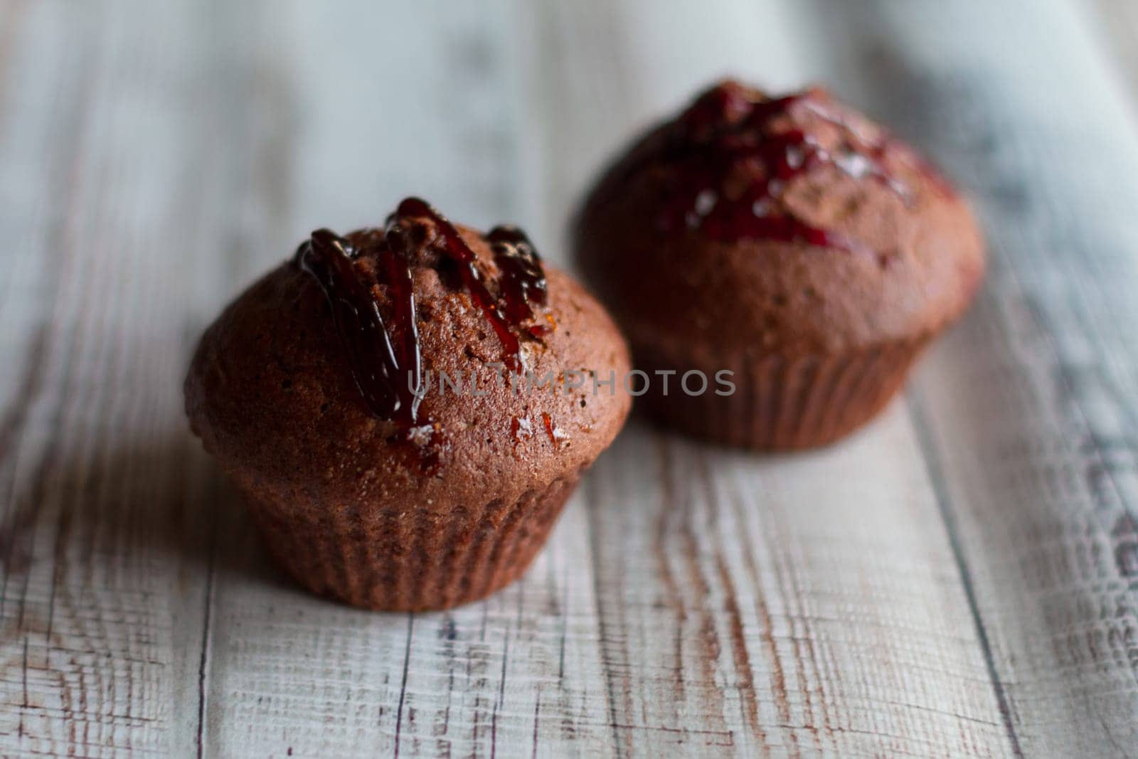 Delicious brownie chocolate cupcakes with nuts and jam