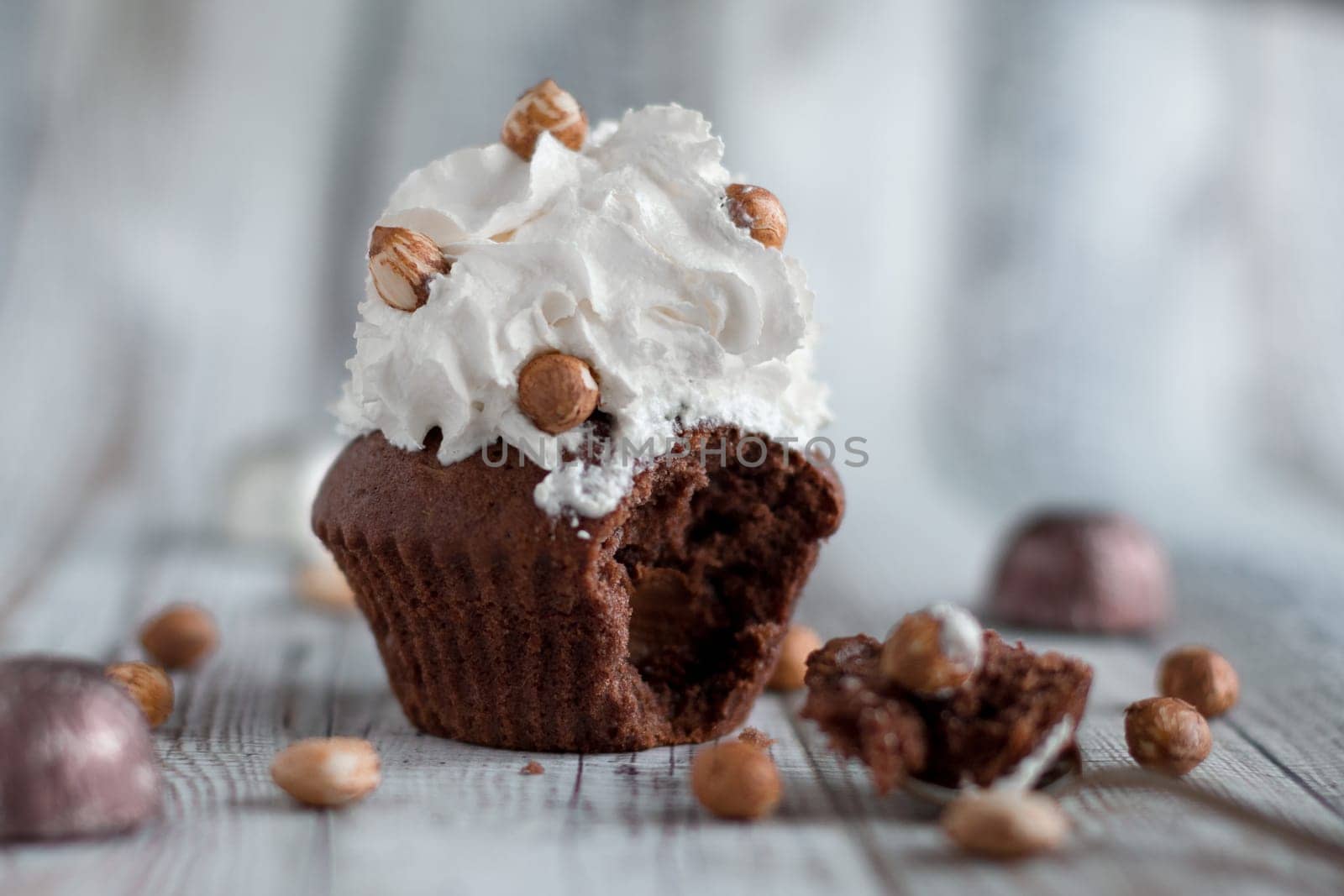 Delicious chocolate brownie muffins with nuts and whipped cream