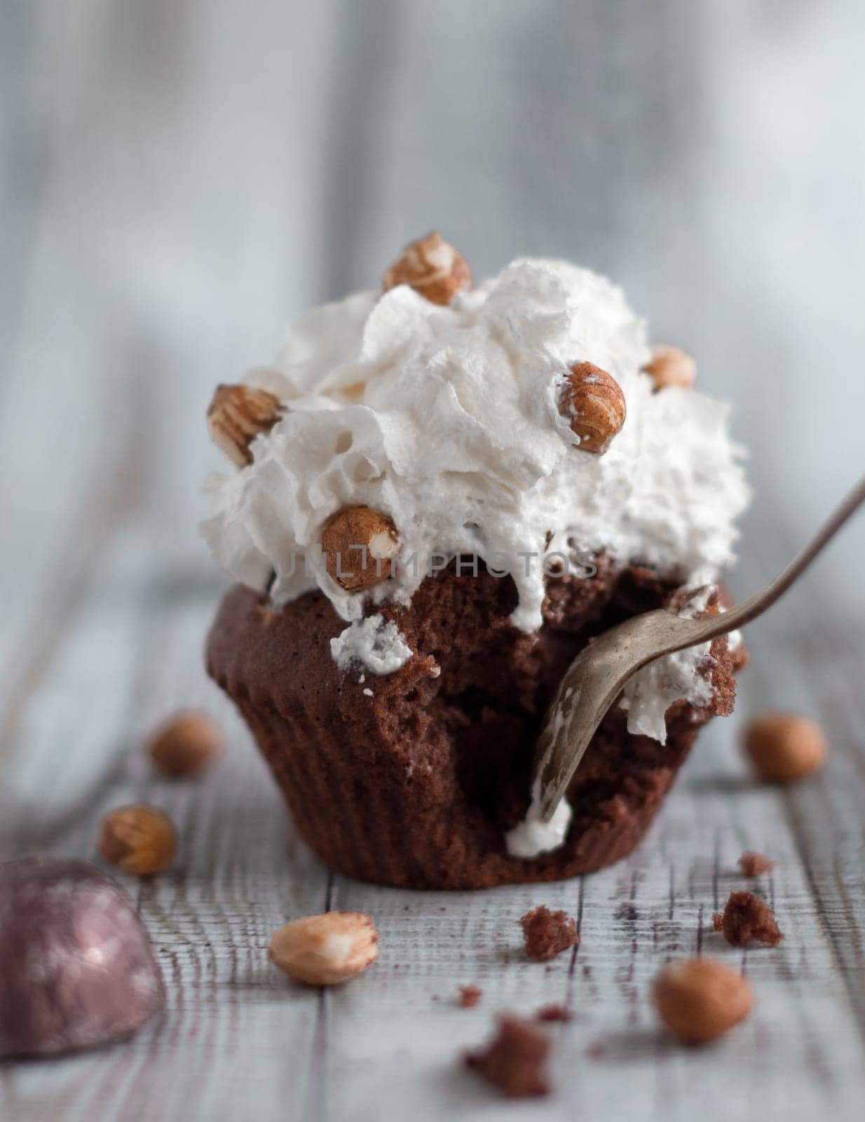 Delicious chocolate brownie muffins with nuts and whipped cream