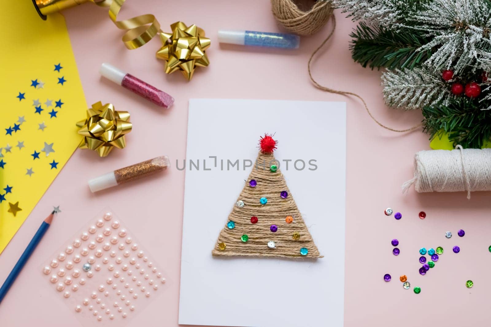 DIY Christmas Design. Decorative Origami Stars, Kraft Paper Envelopes, Greeting Cards, Wrapping Paper Rolls on White Background. Scandinavian Holidays Mockup.