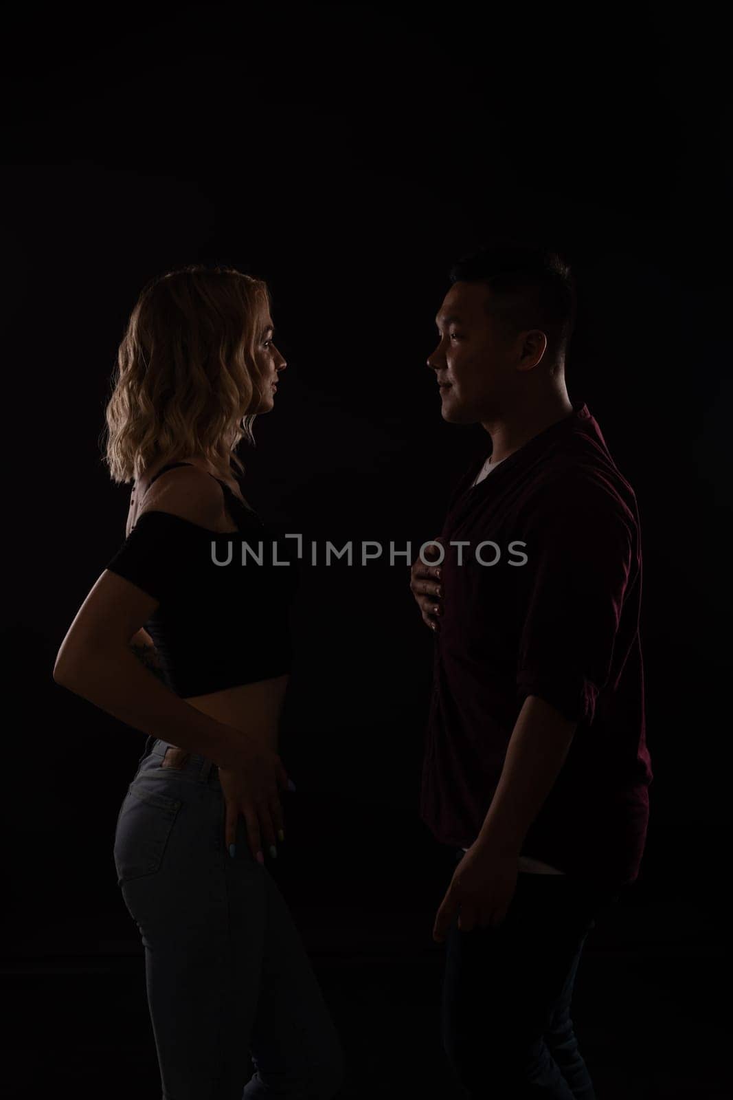 male and female dancers dance bachata kazimba latina in a dark room