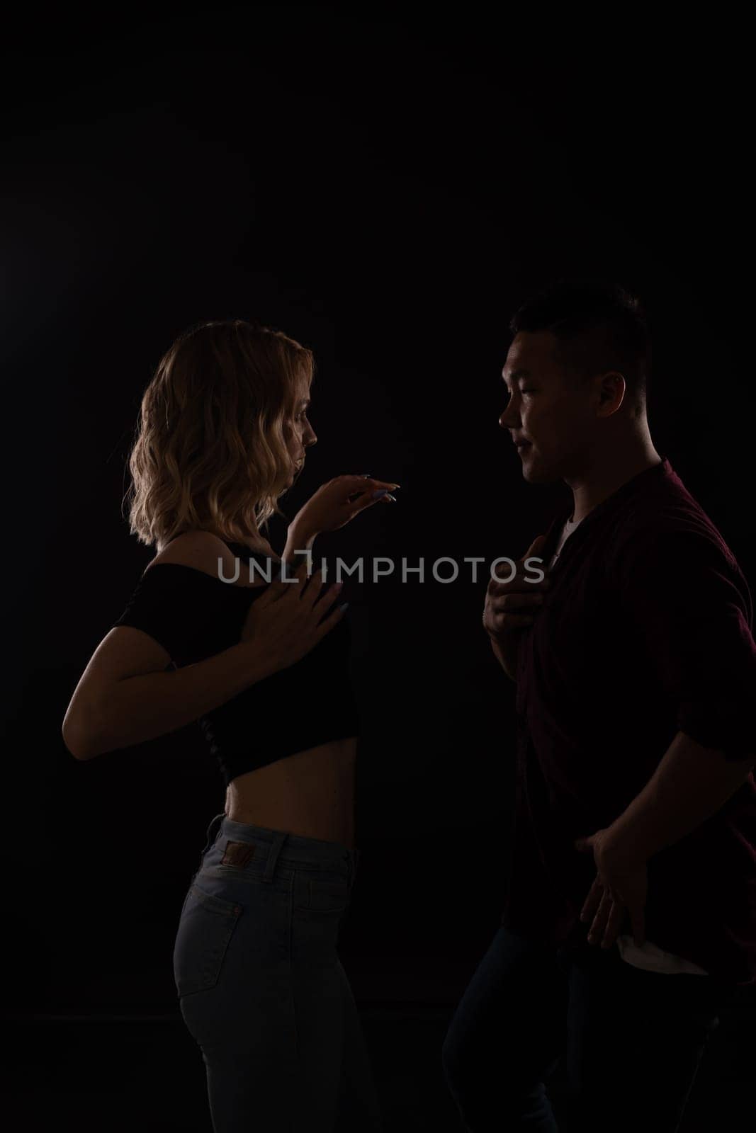 male and female dancers dance bachata kazimba latina in a dark room