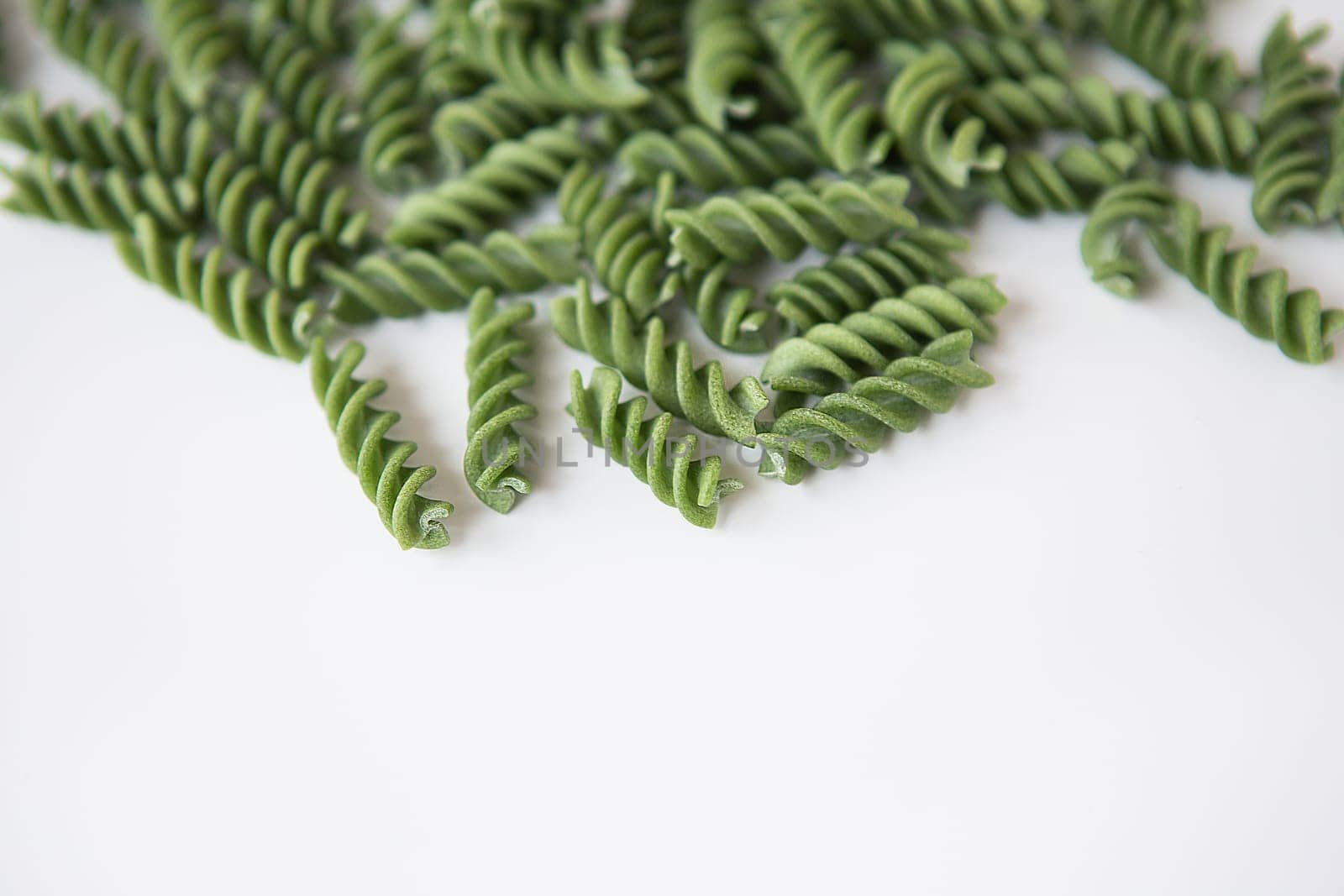 Raw green fusilli pasta, natural based on spinach and spirulina. Delicious and healthy food