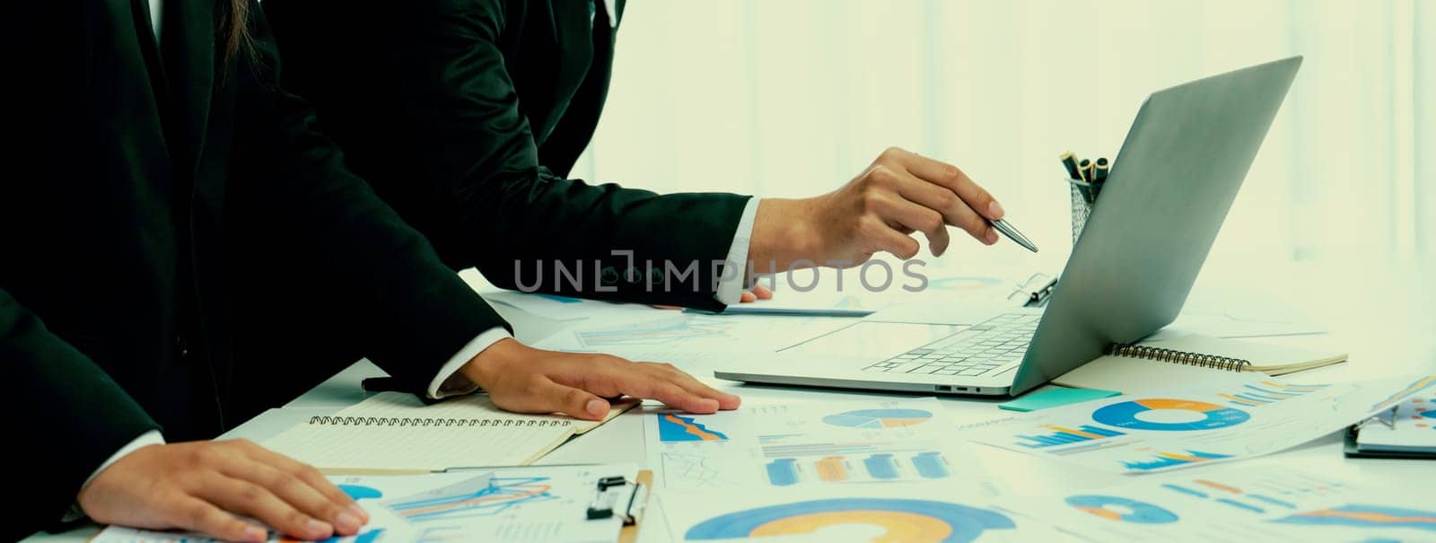 Business people in group meeting in formal attire share idea discussing report for company profit in creative workspace for start up business shot in close up view on group meeting table . Oratory .