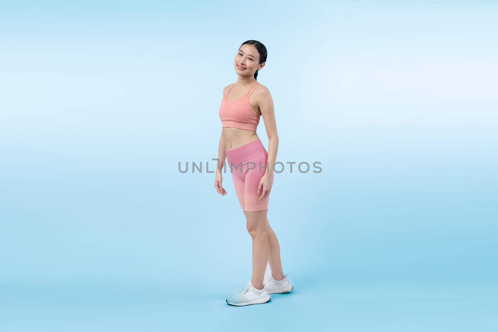 Full body asian woman in sportswear portrait, smiling and posing cheerful gesture. Workout training with attractive girl engage in her pursuit of healthy lifestyle. Isolated background Vigorous