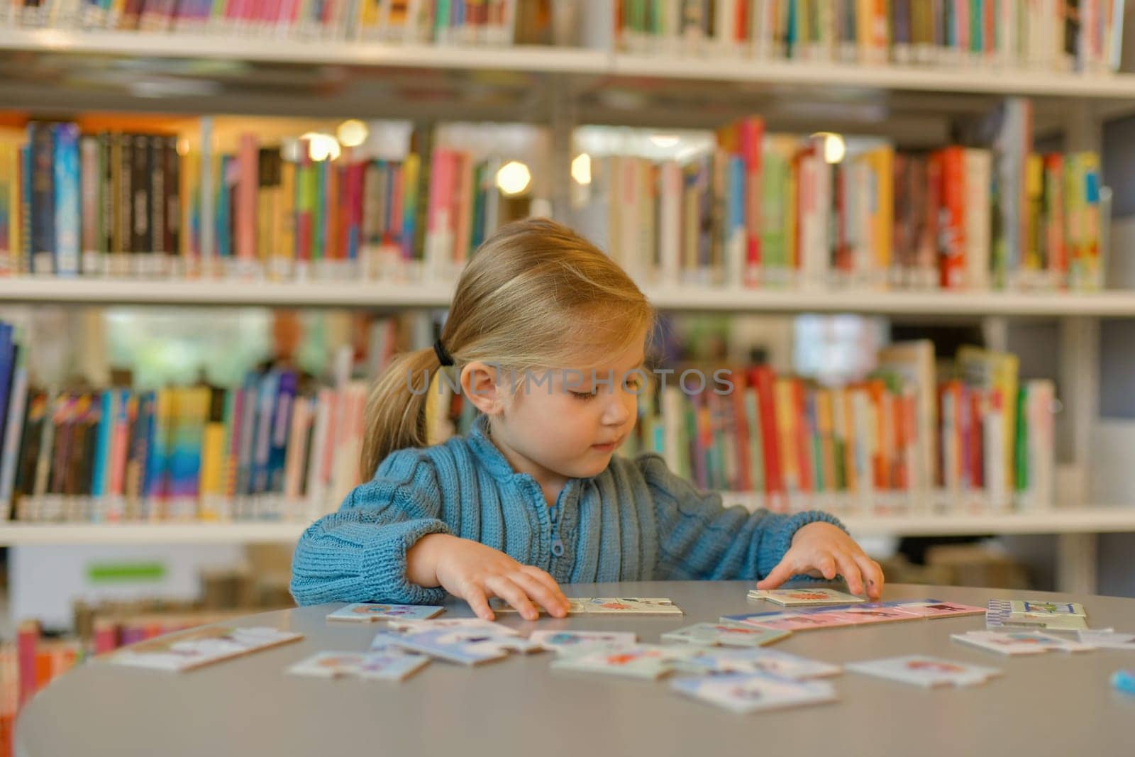 Girl playing puzzle in a library