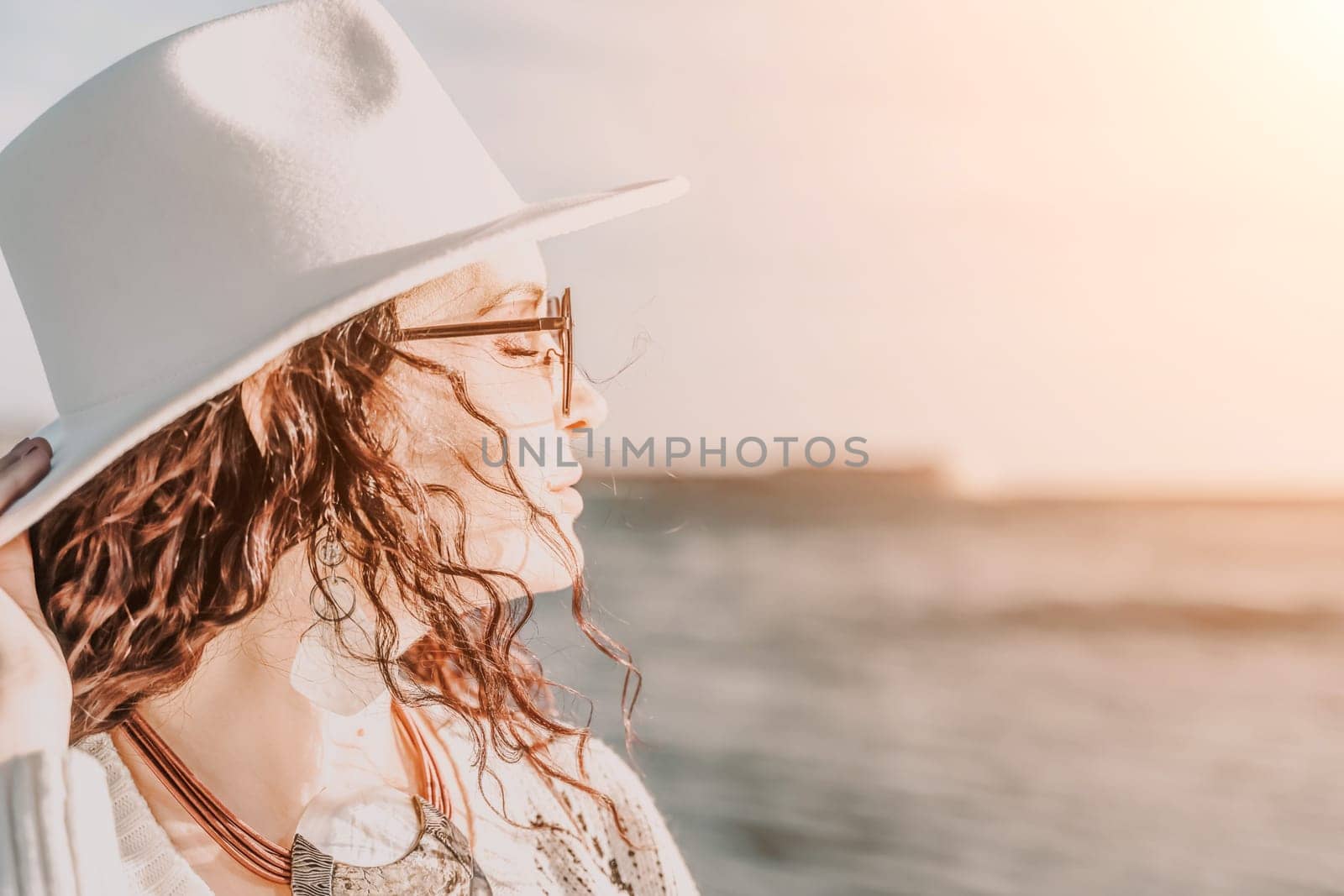 Portrait of a curly haired woman in a white hat and glasses on t by Matiunina