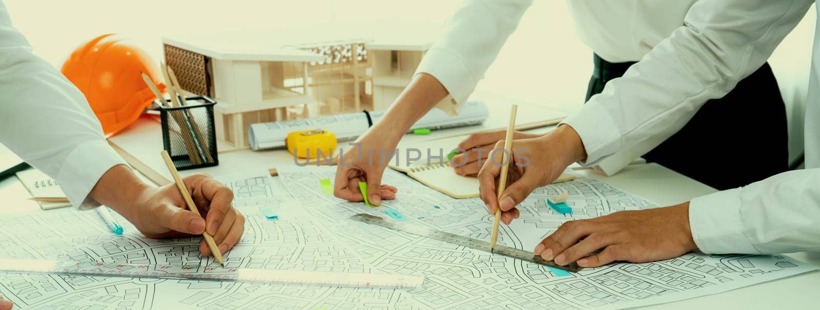 Worker, architect and engineer work on real estate construction project oratory by biancoblue