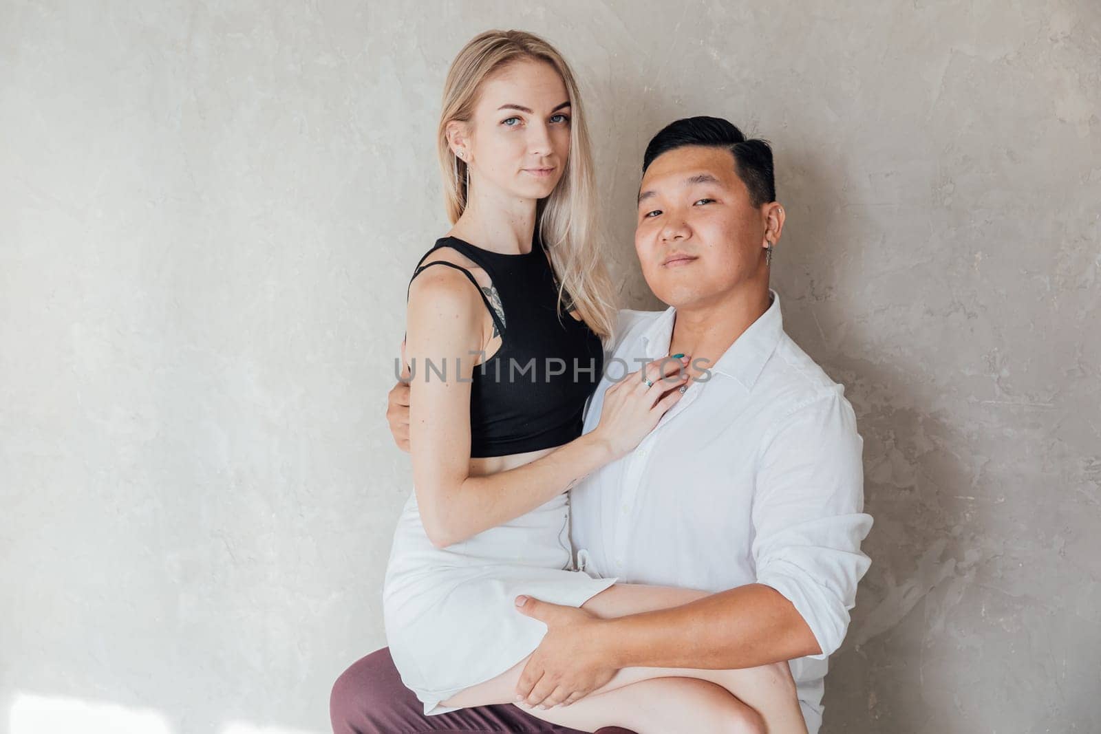a woman and a man sit on a gray background by Simakov