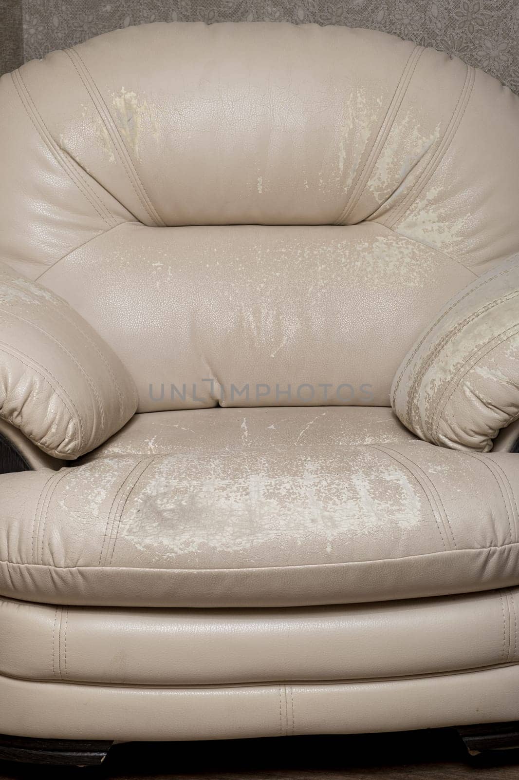 Defects on a white leather sofa. Damaged to leather furniture. Close up of damaged white leather soft tufted furniture. Bad quality leather