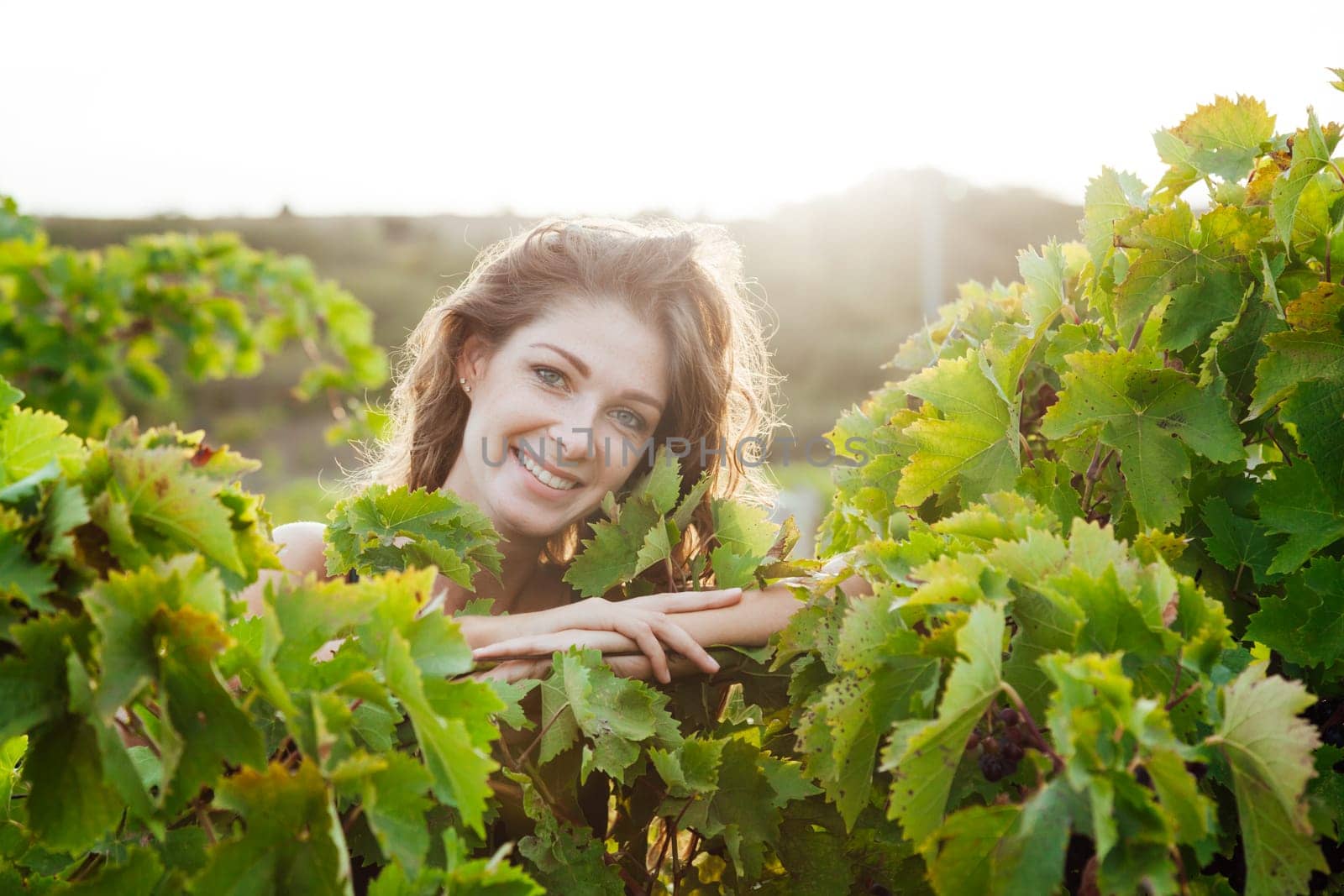 portrait of woman in grape leaves walk