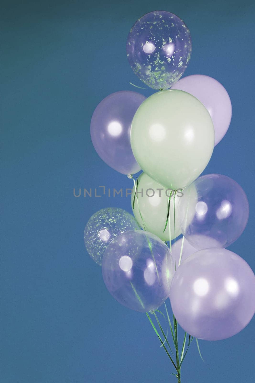 Balloons of light colors - white, light green, transparent on a blue background. by tewolf