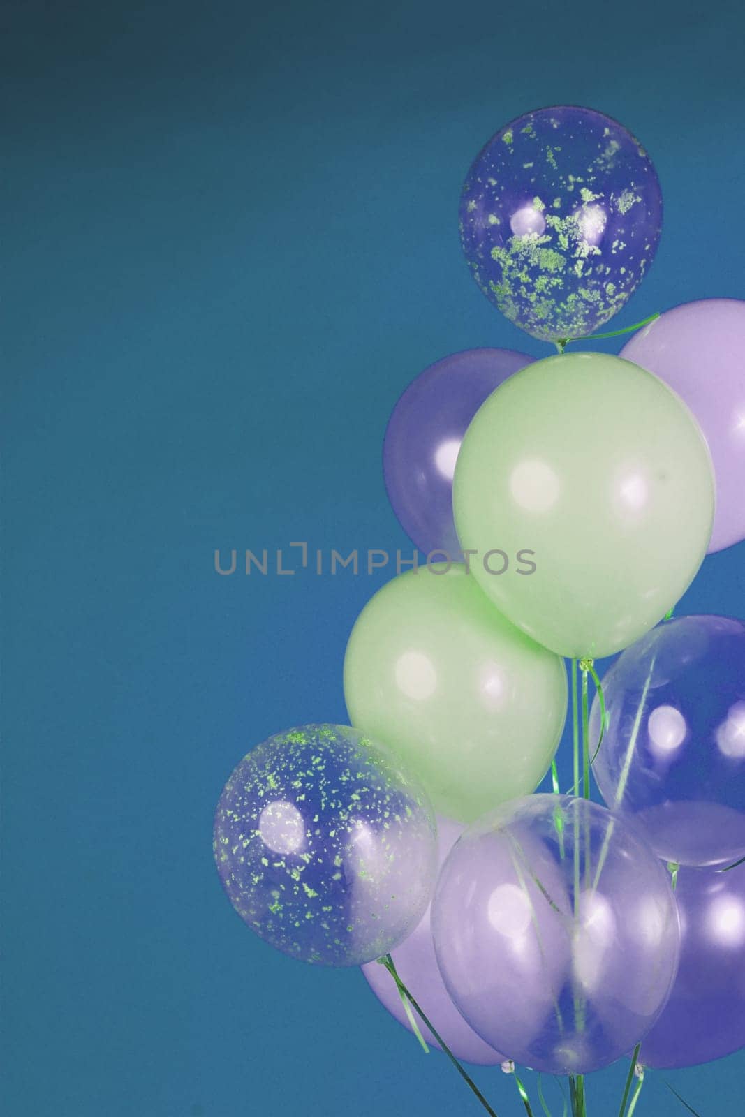 Balloons of light colors - white, light green, transparent on a blue background. by tewolf